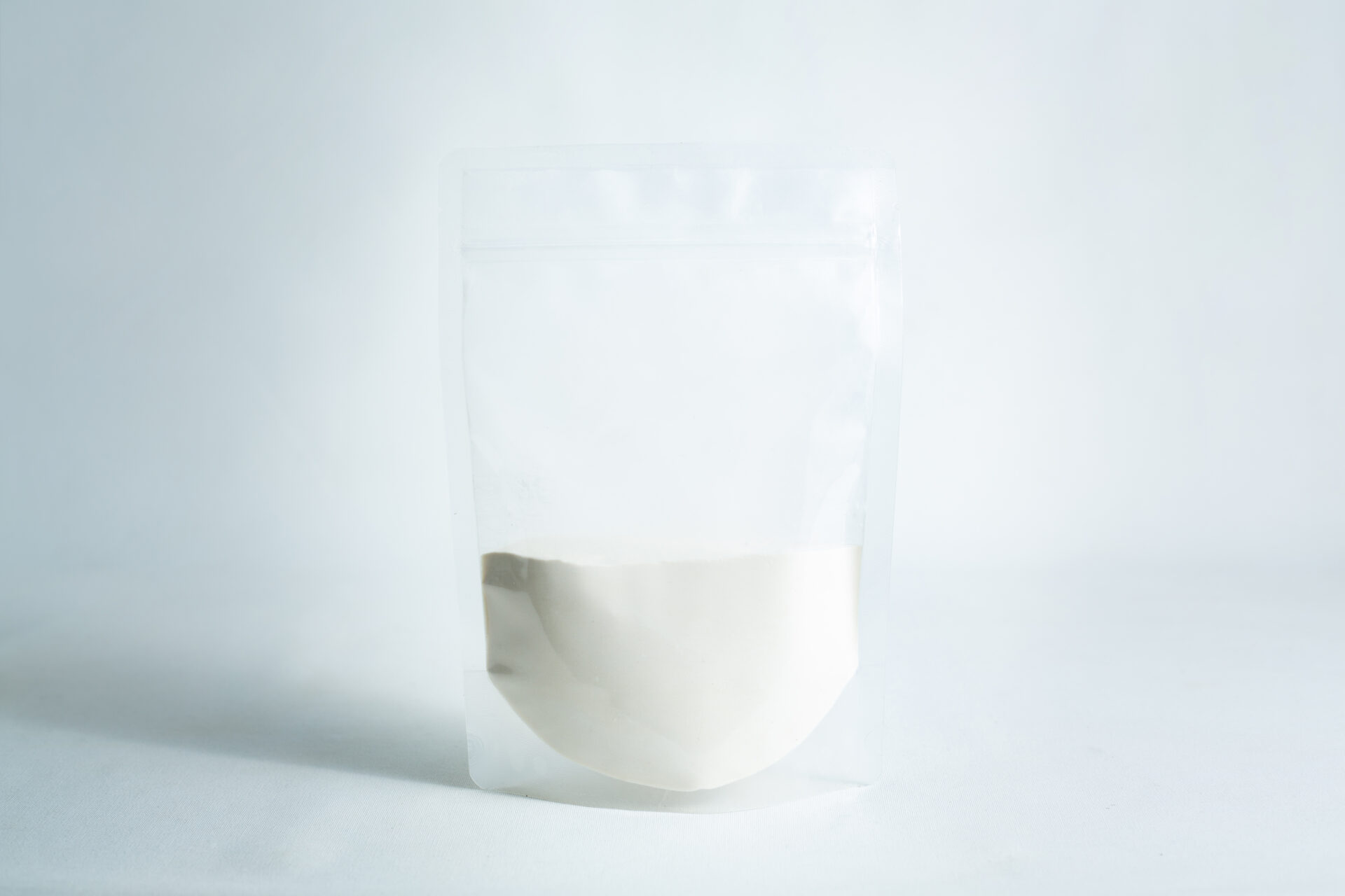 A clear resealable pouch, half-filled with Agar Mix MYAG Antibacterial Malt Extract Yeast powder, sits on a white surface against a light background.
