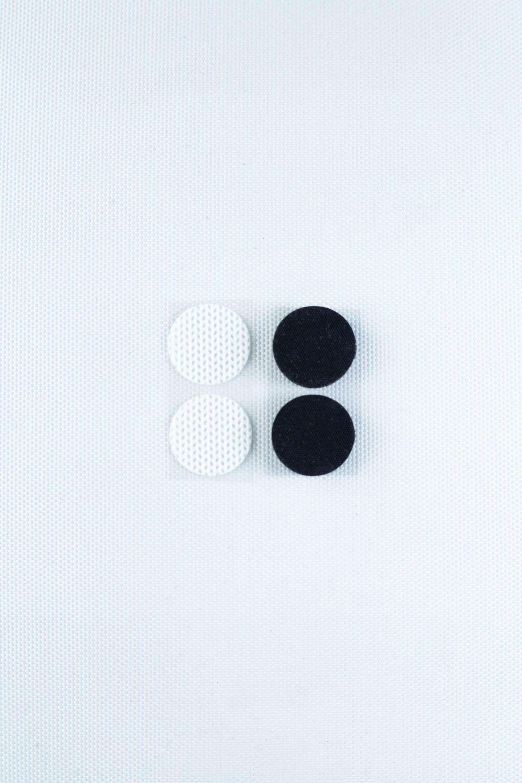 The Self-healing injection port & Air Vent Filter-3M, featuring two white and two black textured components, is arranged in a square on a light textured background.
