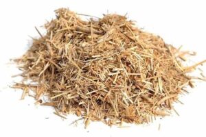A small pile of dried, shredded brown hemp hurd for sale Australia on a white background.