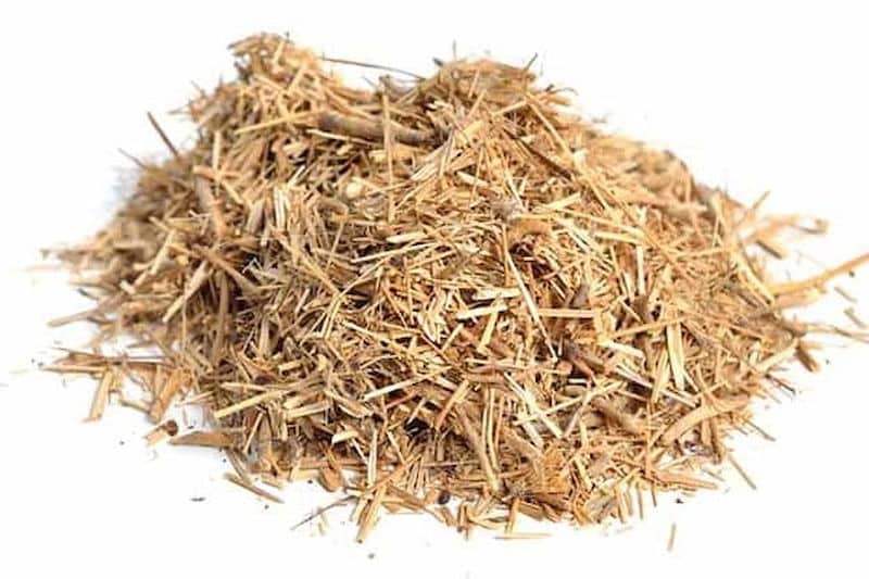 A small pile of dried, shredded brown hemp hurd for sale Australia on a white background.