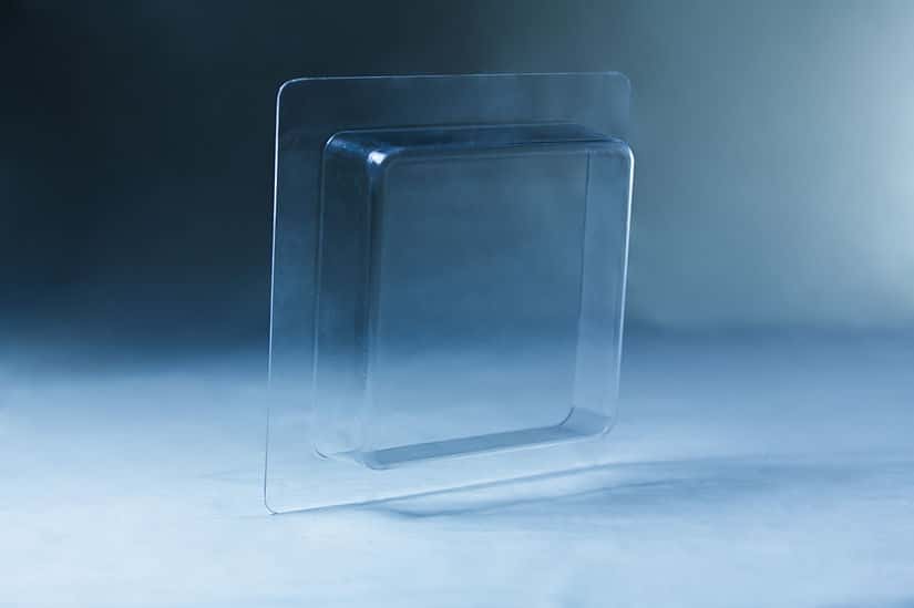 Clear plastic blister packaging set against a blue-toned background, echoing the structured design of the Mycelium Mould Growth form – Paver (Reusable).