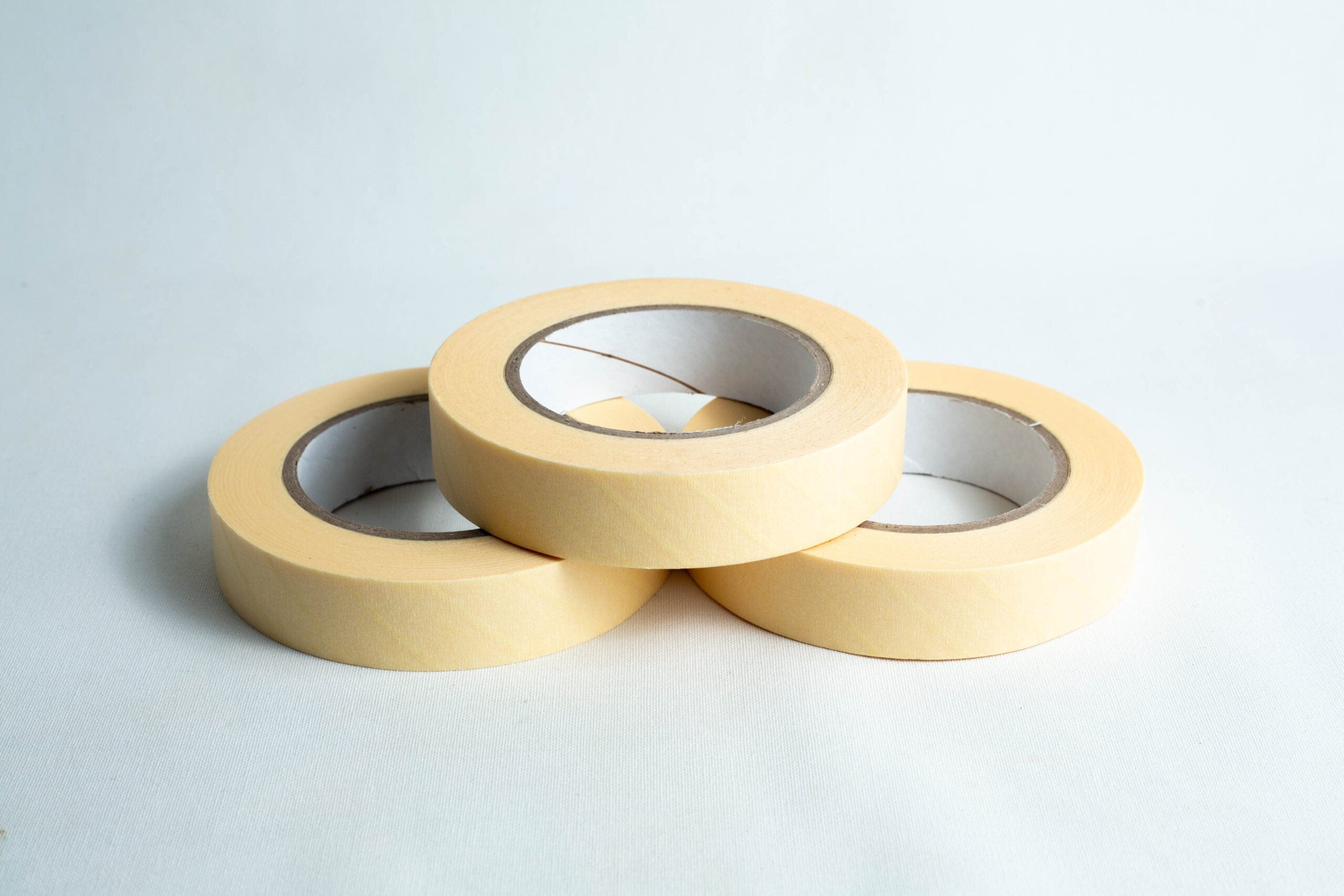 Three rolls of autoclave sterilisation indicator tape 25mm x 50m are arranged in a triangle on a white surface.