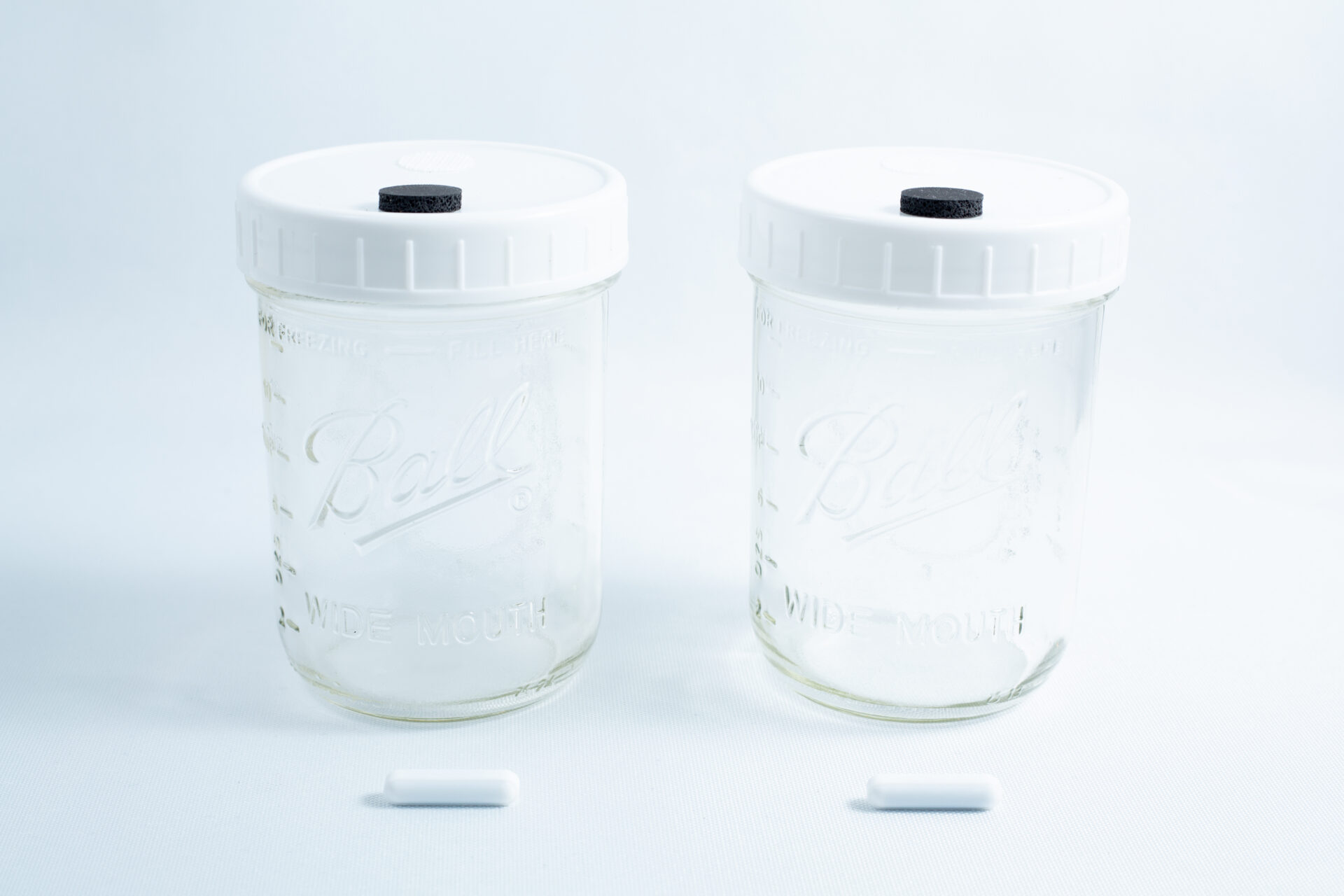 Two Mycology Ball mason jars, 1L each, genuine and autoclavable, with white lids featuring injection ports and air vents, displayed on a white background.