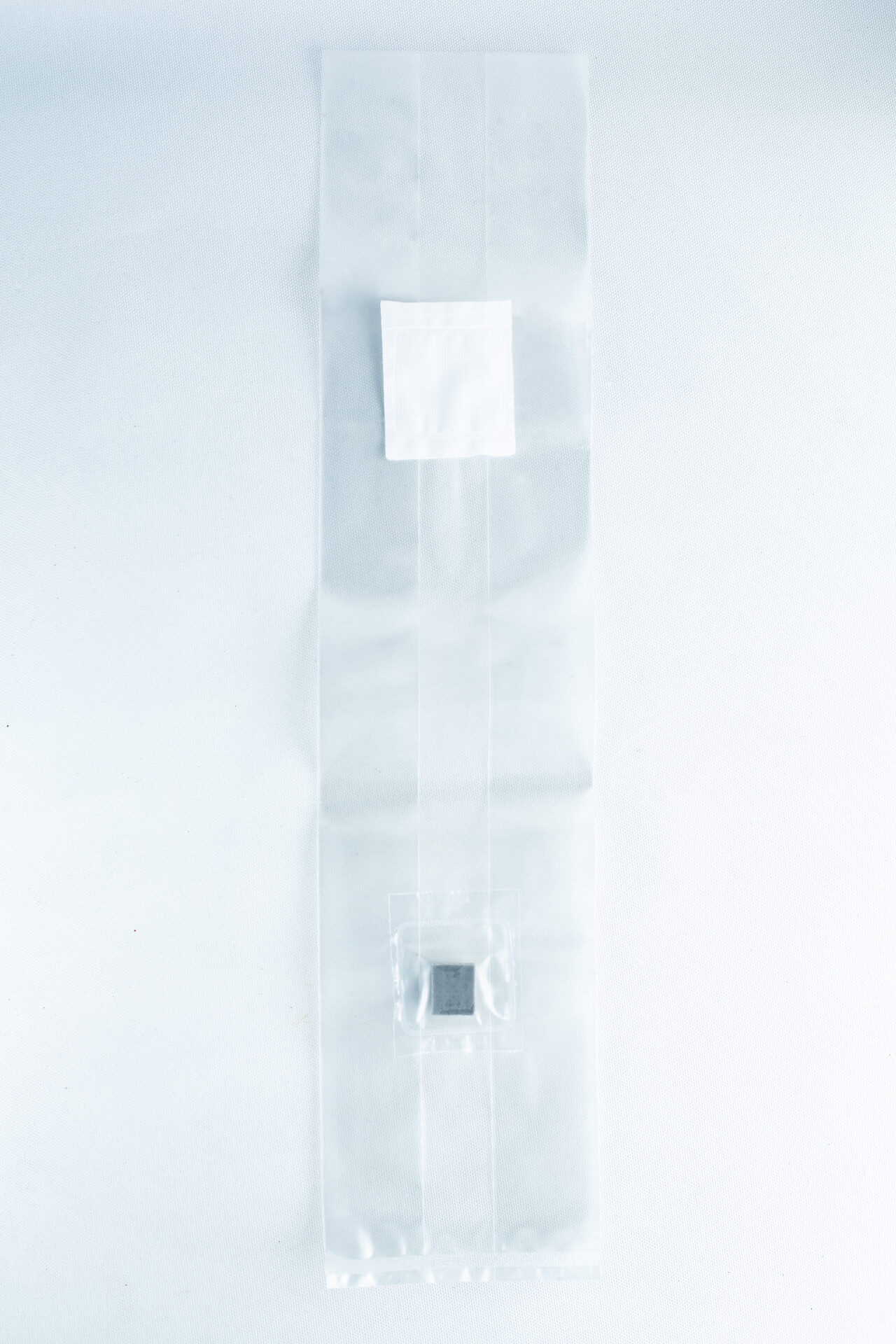 The Mushroom Grow Bags Unicorn for spawn and substrate is a clear plastic bag with a white label and a small dark square inside, perfect for mushroom cultivation, shown on a white background.