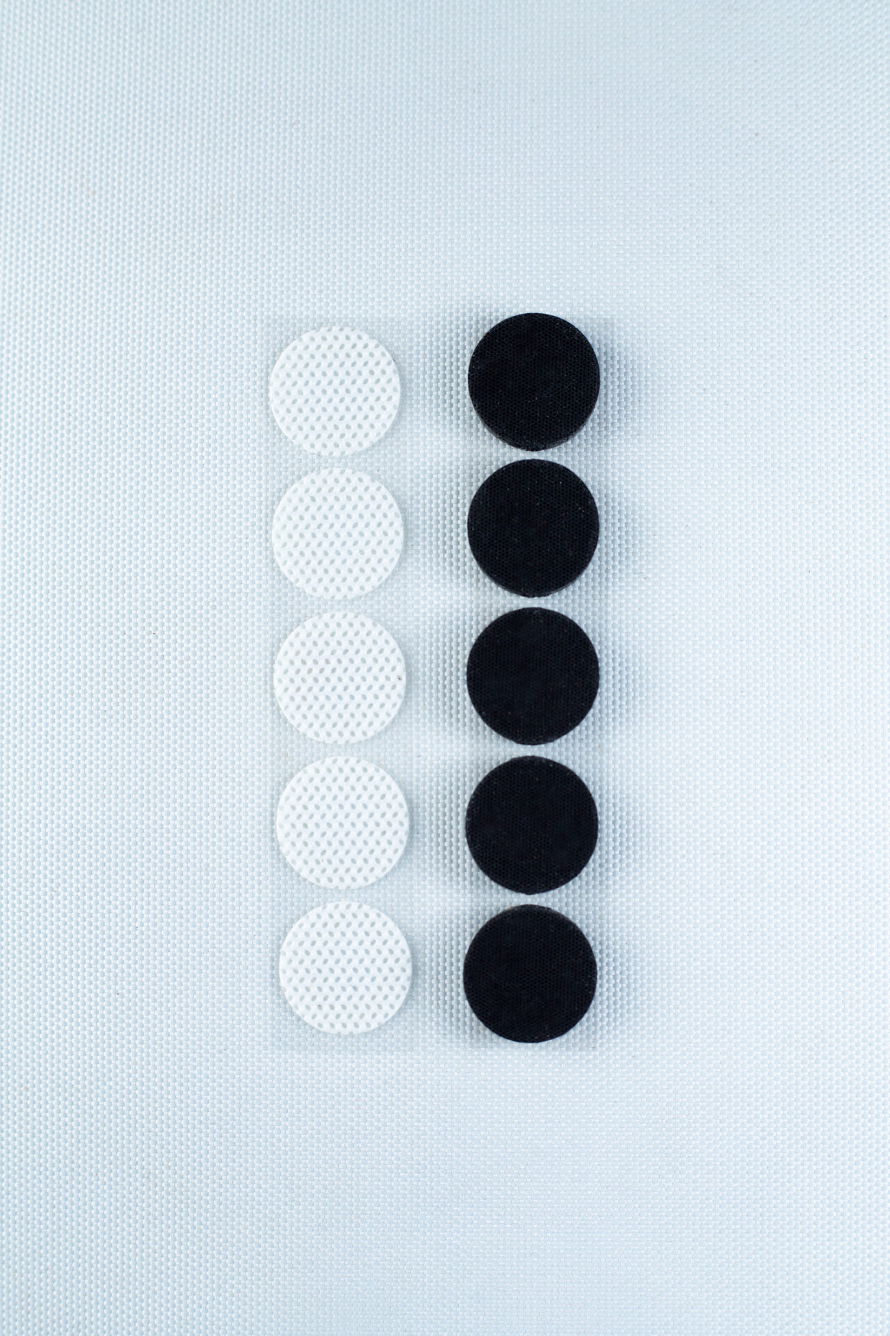 Six white and six black circles, resembling the Self-healing injection port & Air Vent Filter-3M, are arranged in two vertical lines on a white textured background.