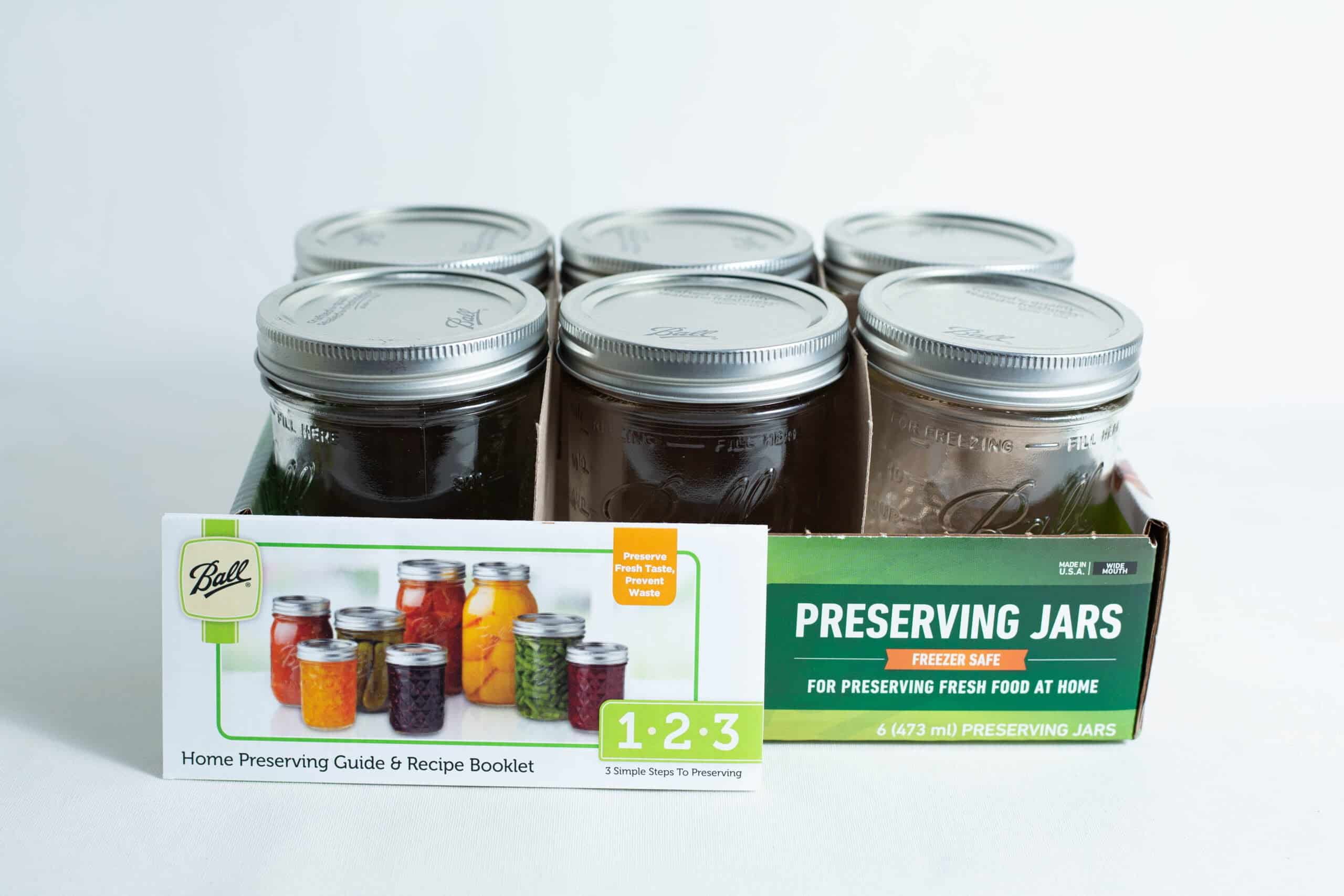 Ball Mason pint jars wide mouth set of 6 includes a box and a booklet with colourful preserved foods pictured in jars on the cover.