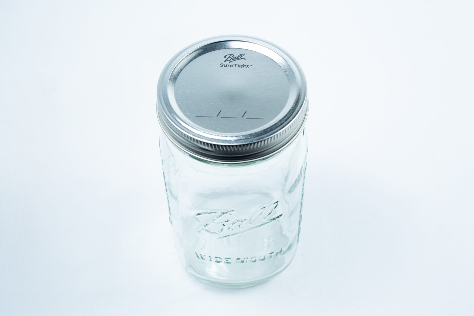 Set of 12 Ball mason jars, 1 litre each, with metal lids, shown on a white background. These classic autoclavable glass jars are ideal for safe storage, preserving, and sterilisation.