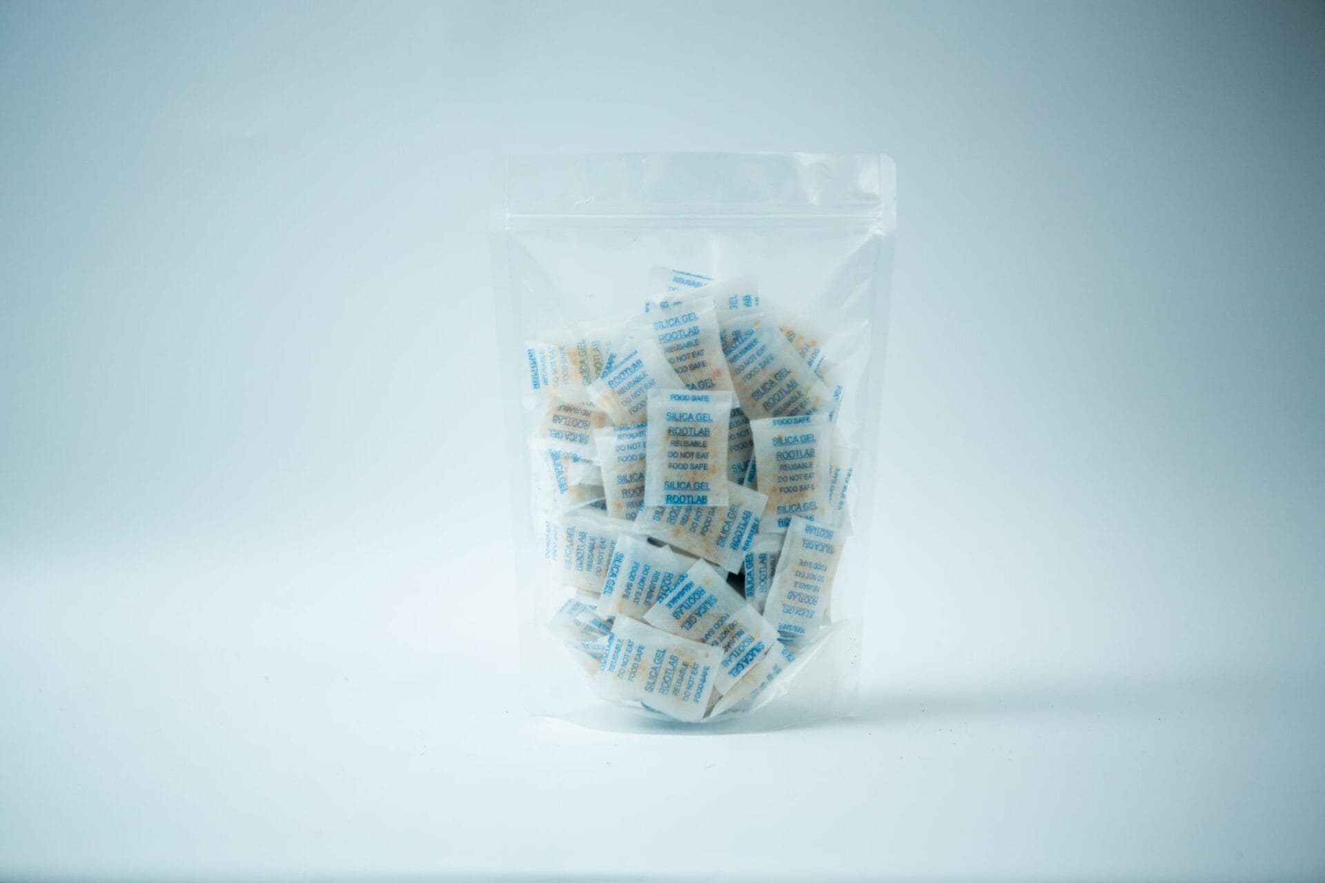 A clear plastic bag containing Desiccant Silica Gel 5g | Reusable, with each packet individually wrapped, displayed on a white background.