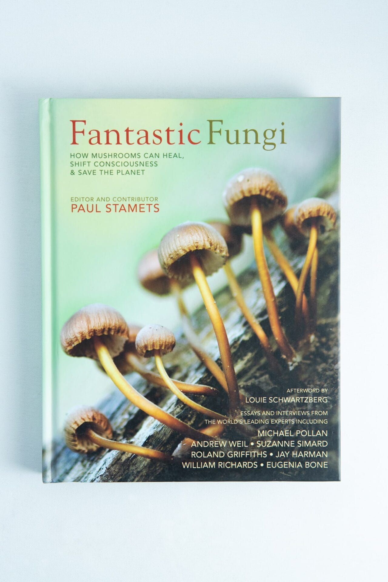 Book cover of Fantastic Fungi by Louie Schwartzberg, showing mushrooms sprouting from a log against a light background.