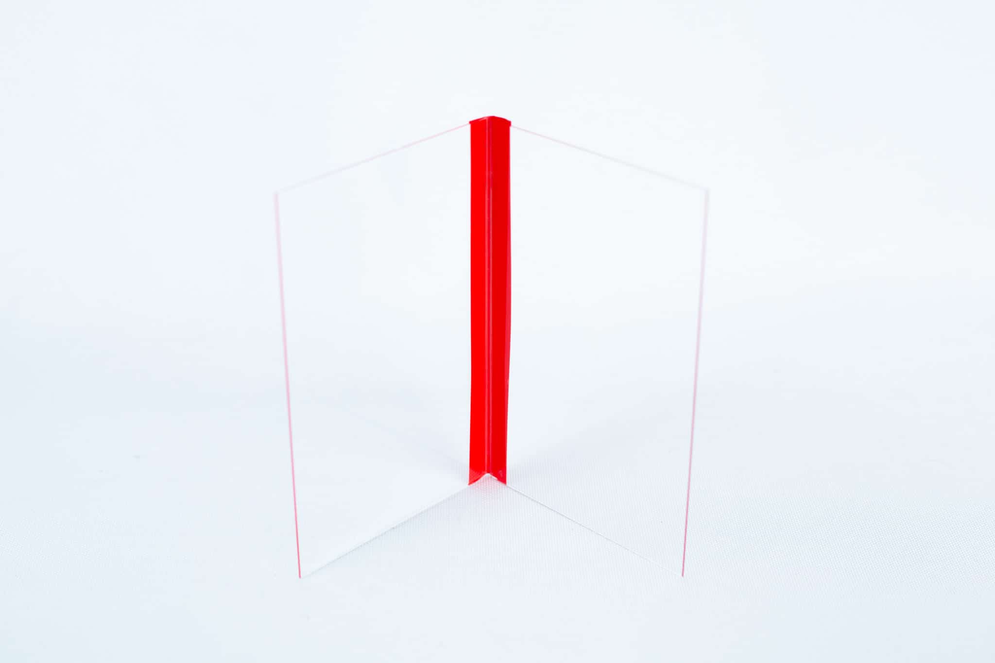 The Glass Spore Print Slides booklet (12.8cm x 8.5cm x 1mm) includes two clear acrylic sheets joined at a right angle with a red hinge—ideal for securely displaying and preserving visible spore prints.