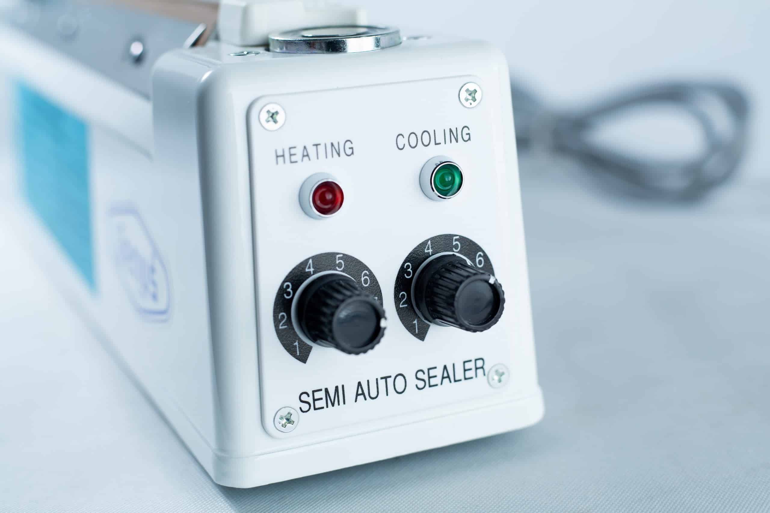 Close-up of the Heat Sealer 30cm Seal Width 5mm with cutter and magnet, featuring heating and cooling controls plus indicator lights.