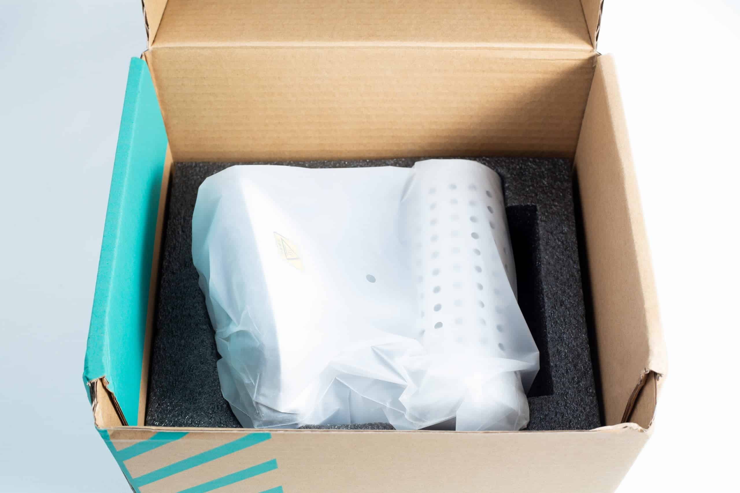 An Infrared Steriliser Bacti Cinerator Lab tool, white and wrapped in plastic, is placed inside a cardboard box with protective foam.