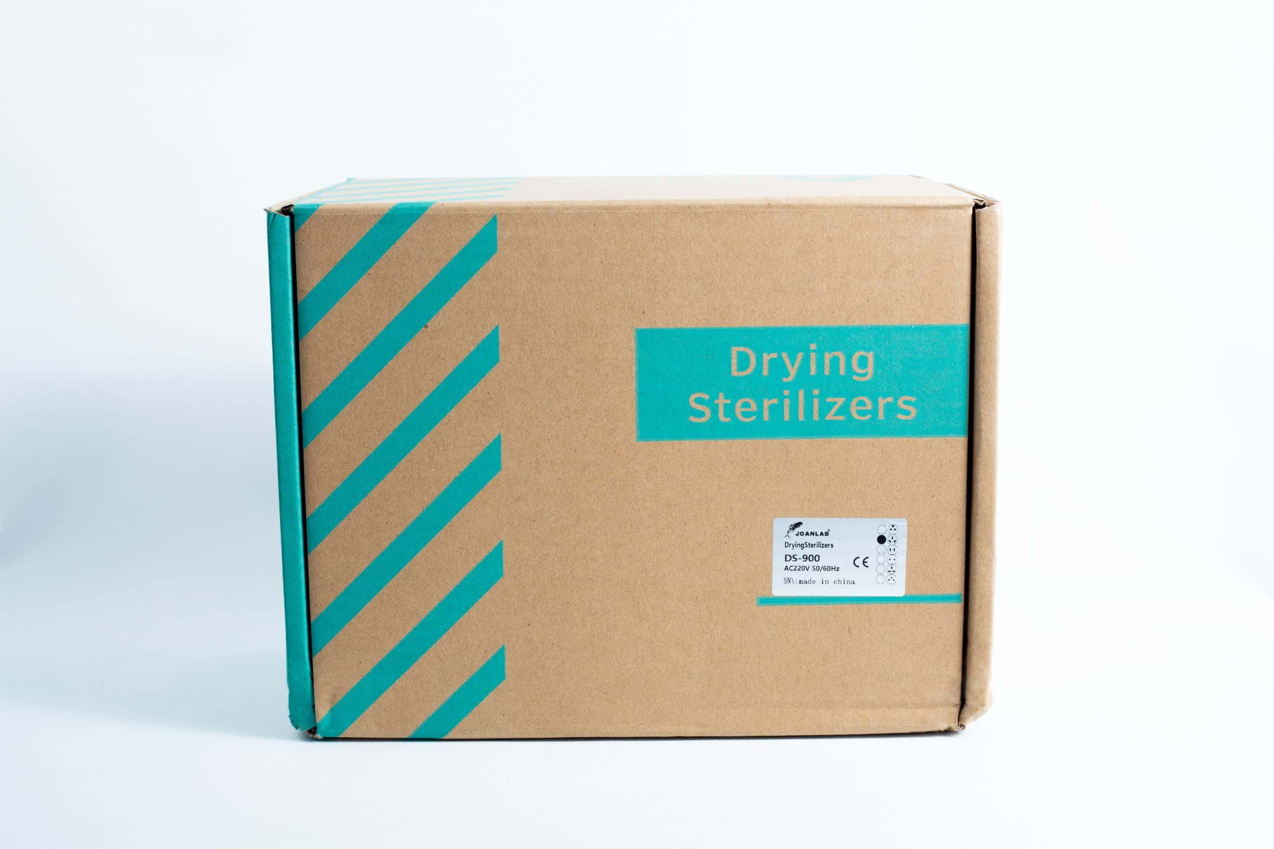 A cardboard box with teal diagonal stripes on white, labelled Infrared Steriliser Bacti Cinerator Lab tool, designed for storing lab steriliser units.