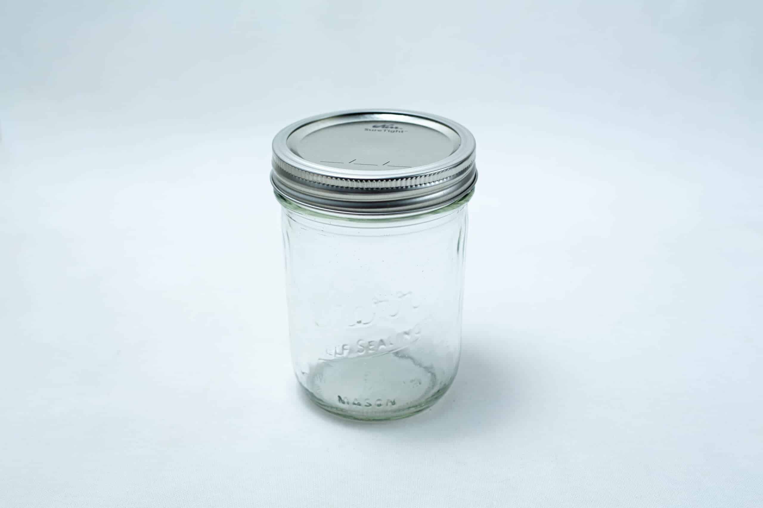 A set of 12 Kerr wide mouth Mason jars, pint size (473ml), with silver lids and bands is displayed on a plain white background.
