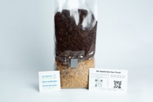 A clear 1kg Masters Mix + Millet All-in-one Mushroom Bag filled with brown and yellow seeds, shown with two small info cards in front.