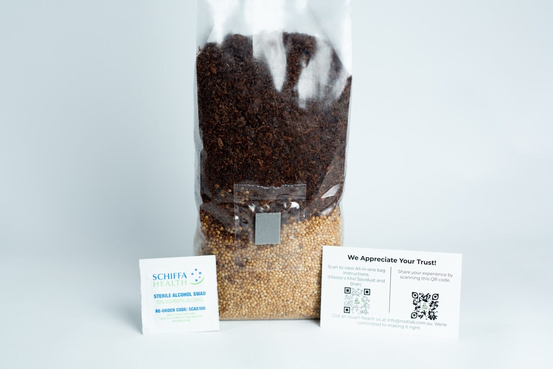 A clear 1kg Masters Mix + Millet All-in-one Mushroom Bag filled with brown and yellow seeds, shown with two small info cards in front.