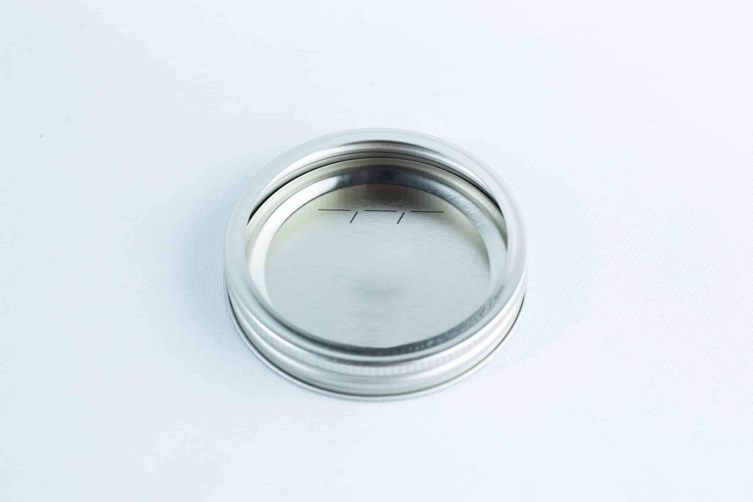 The Self-healing injection port & Air Vent Filter-3M is a silver metal canning jar lid ring with an injection port and air vent filter, shown from above on a white background.