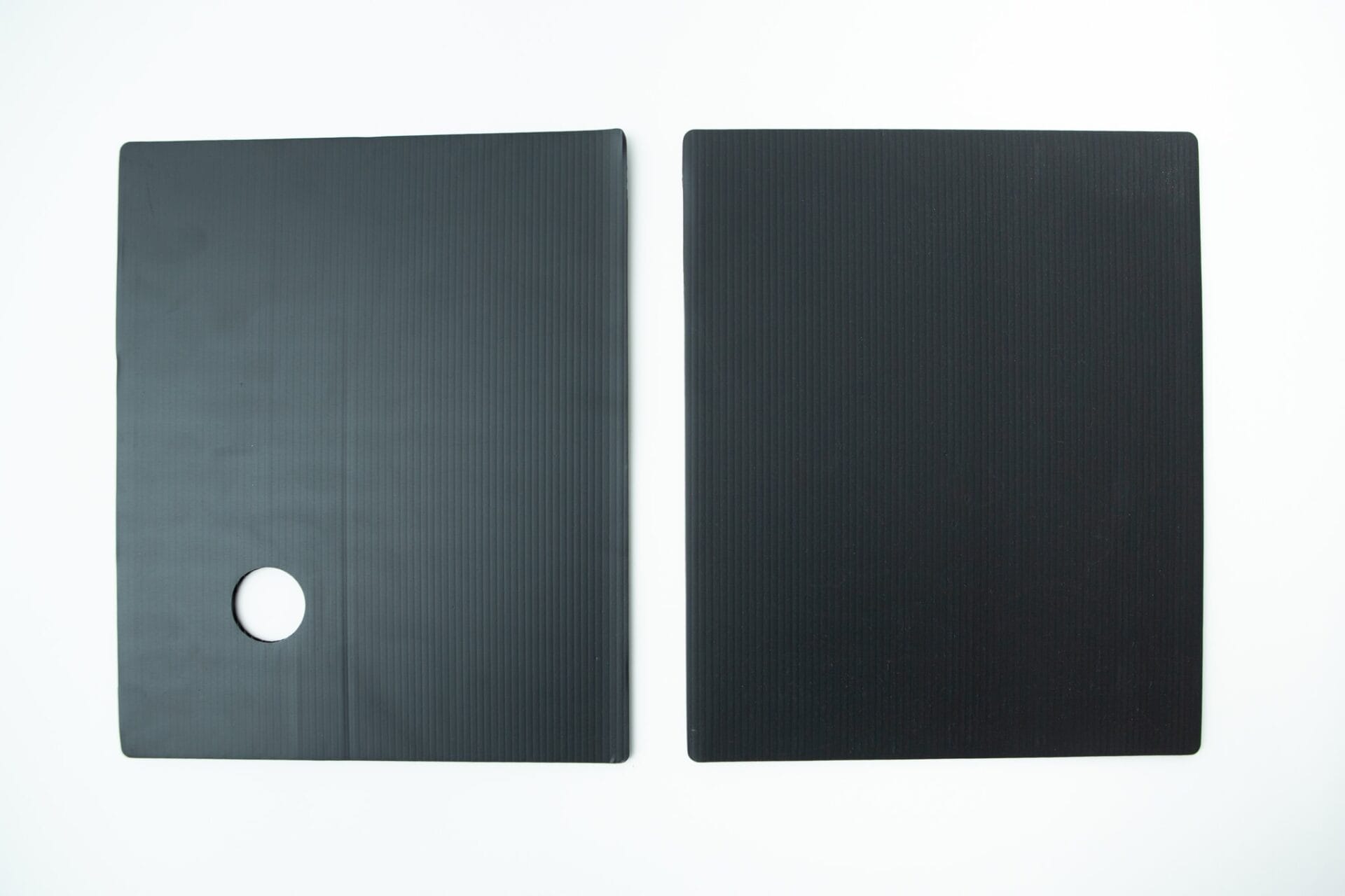 Two black rectangular mats, one with a circular hole, placed side by side on a white background—perfect for use with the Inflatable Monotub Kit for Growing Mushrooms - Boomer Shroomer V 2.0.