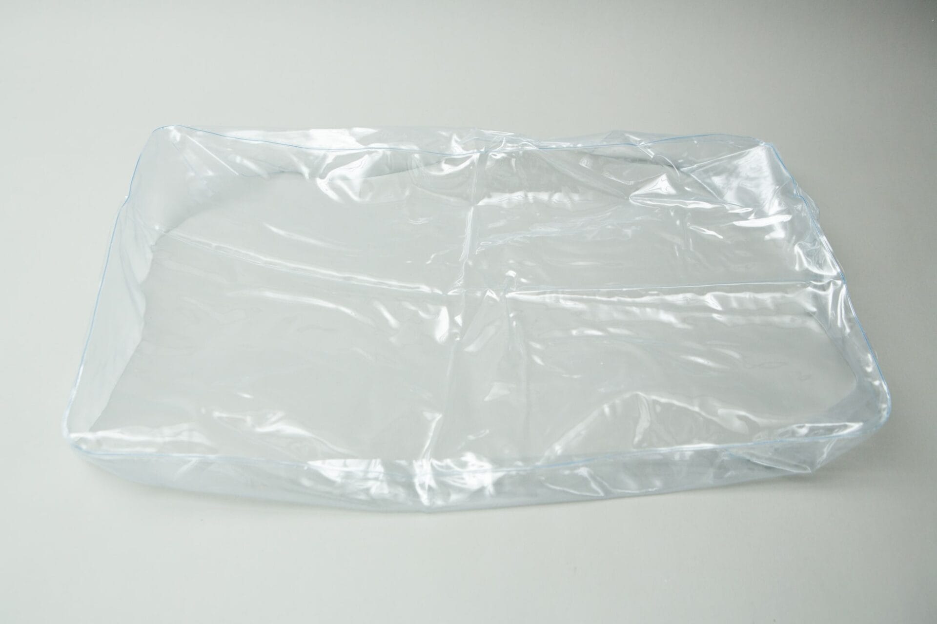 The Inflatable monotub kit for Growing mushrooms—Boomer Shroomer V 2.0—sits empty and transparent on a white surface, perfect for mushroom cultivation set-ups.