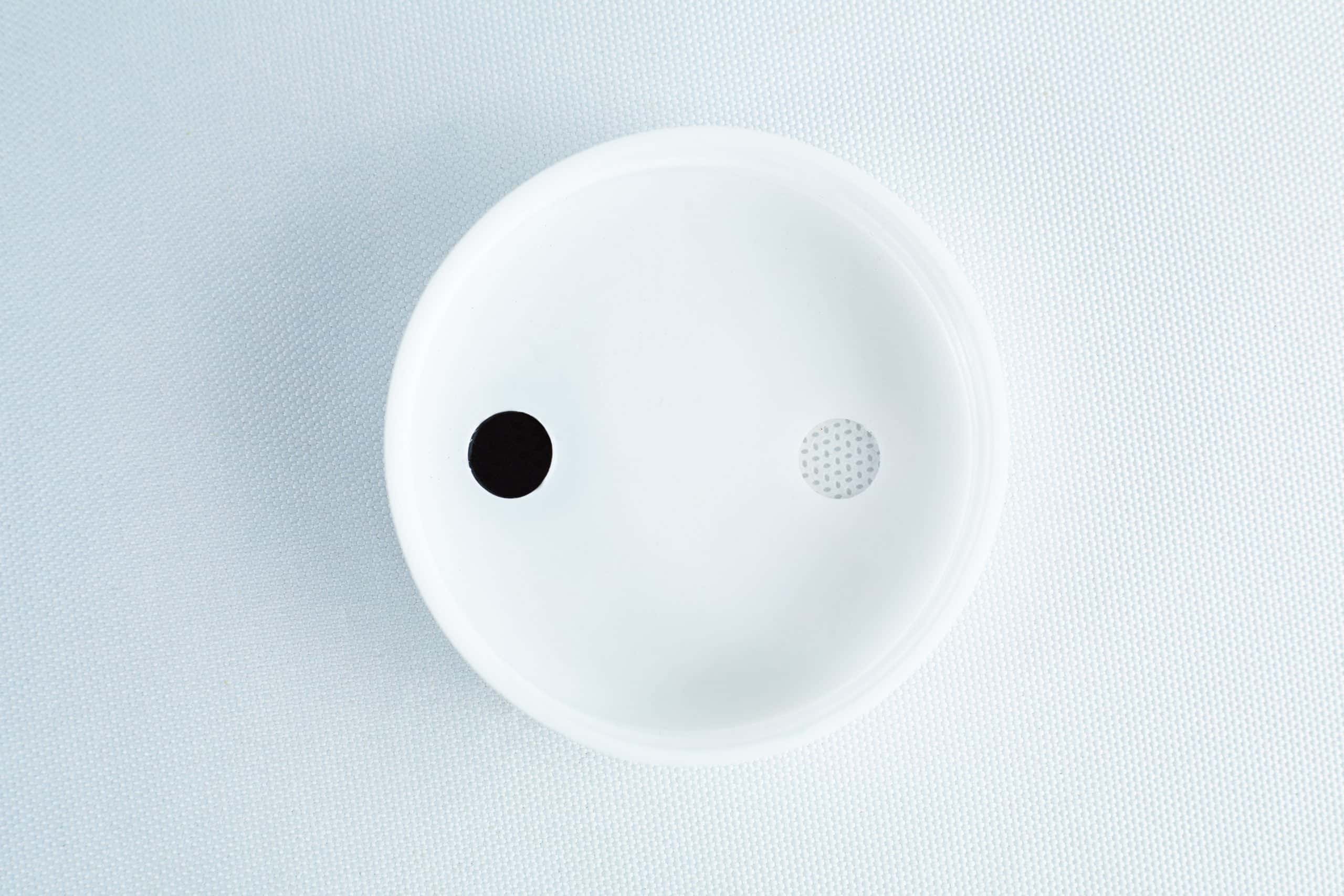 The Self-healing injection port & Air Vent Filter-3M, featuring a white dish with a solid black dot and small perforated circle, is shown on a textured white background.