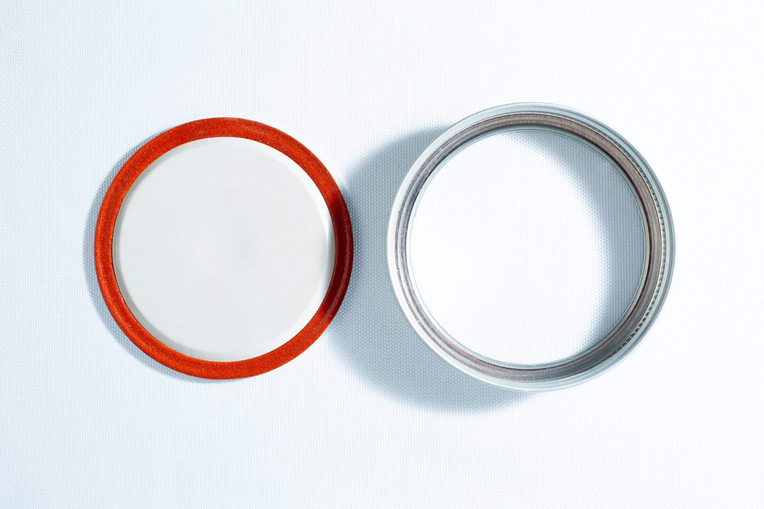 The Self-healing injection port & Air Vent Filter-3M, with a metal ring, are displayed side by side on a white surface.