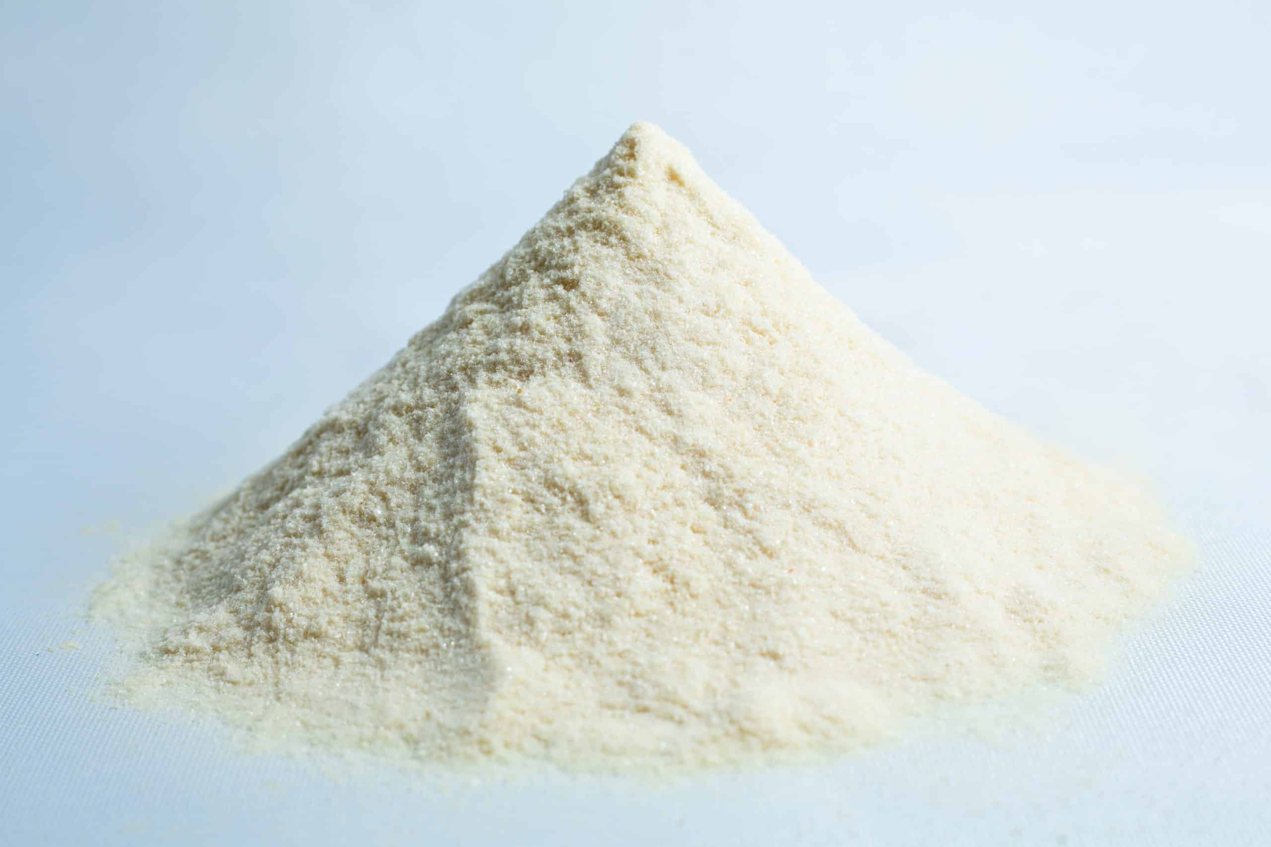 A small mound of fine, off-white powder—Agar Mix MYAG Antibacterial Malt Extract Yeast—rests on a light surface.