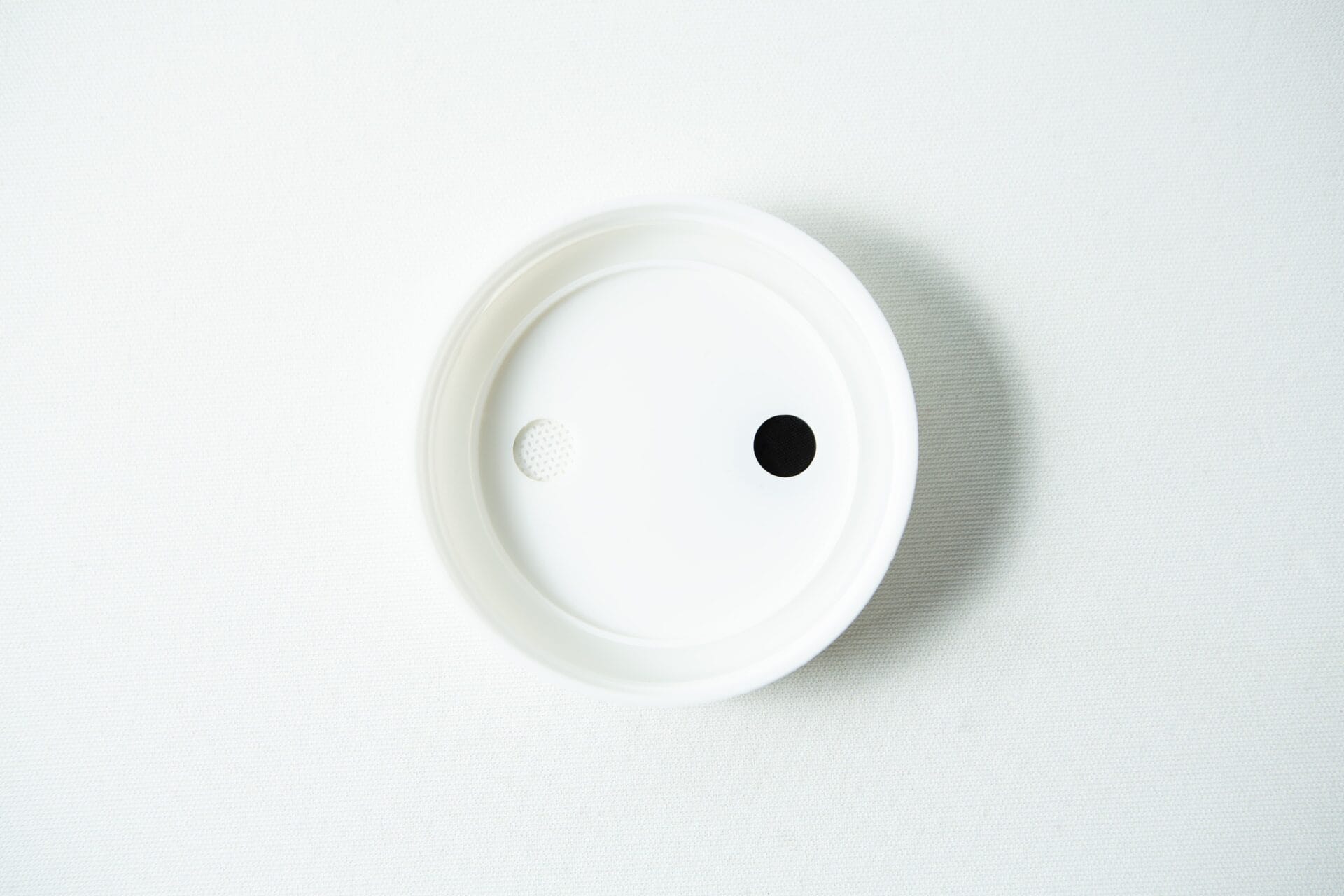 The Mycology pre-made Wide Mouth Mason Jar Lids in white feature an injection port and air filter, designed for wide mouth jars. Ideal for autoclavable mycology setups, this plastic lid includes one black dot and one textured hole.