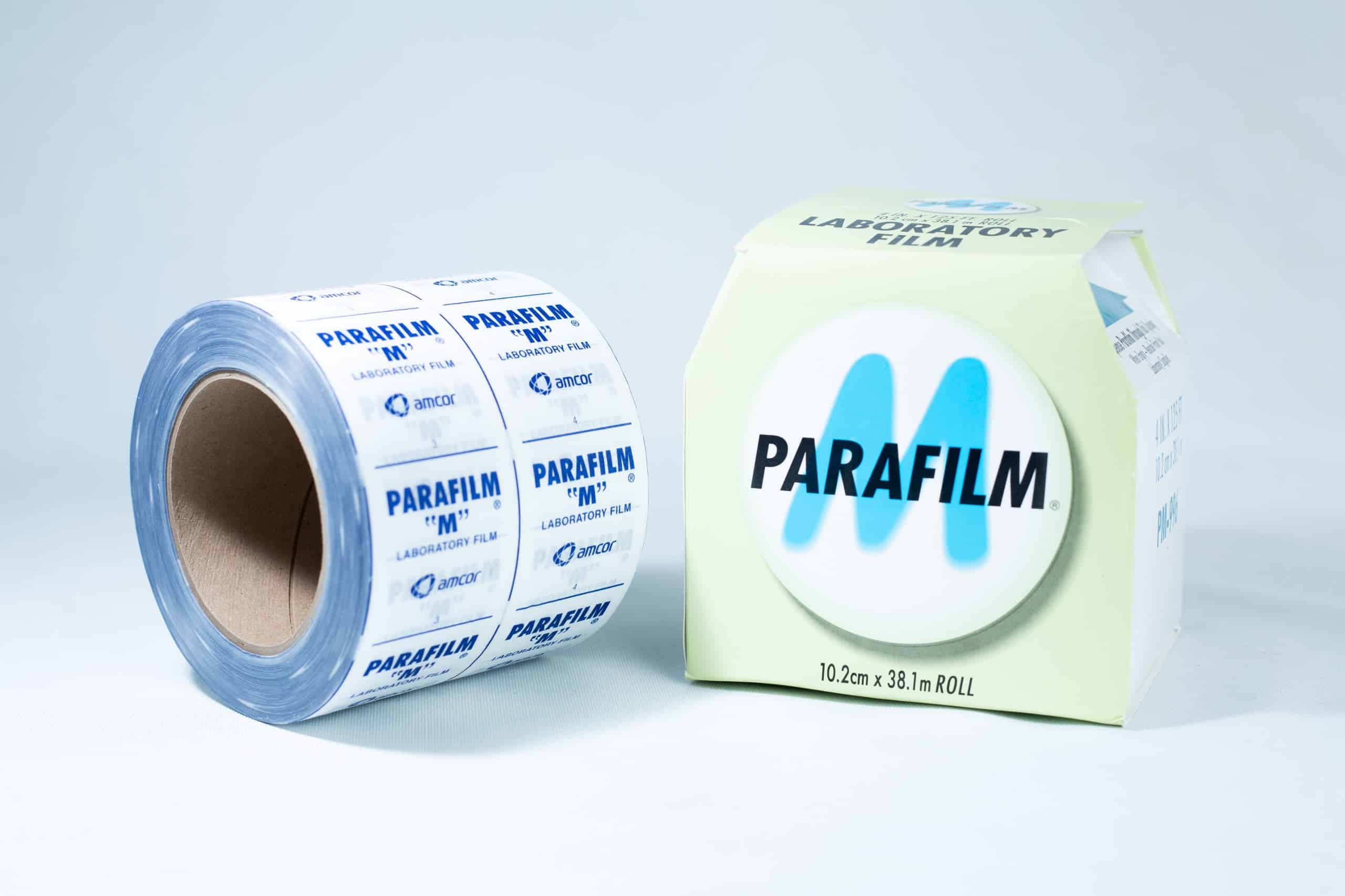 A roll of Parafilm Lab sealing film is placed next to its packaging box on a white surface.