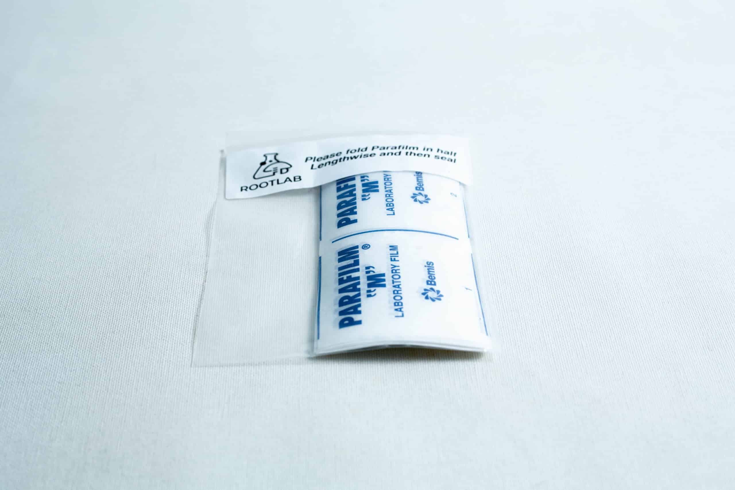 A packet of Pre-cut Parafilm strips 10x Lab cut film in clear packaging displayed on a white surface.