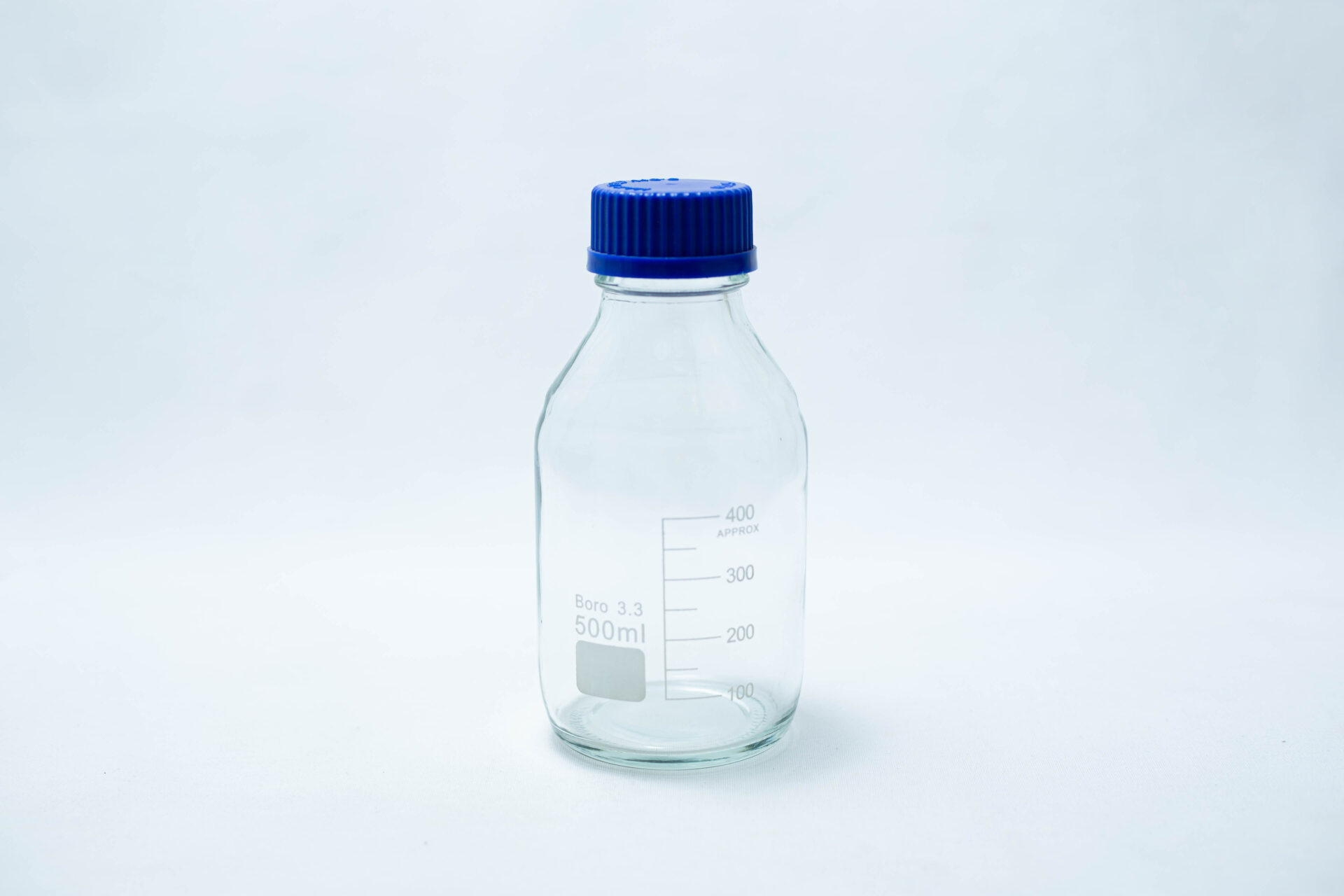 A 500ml reagent bottle with a blue screw cap is displayed against a white background.