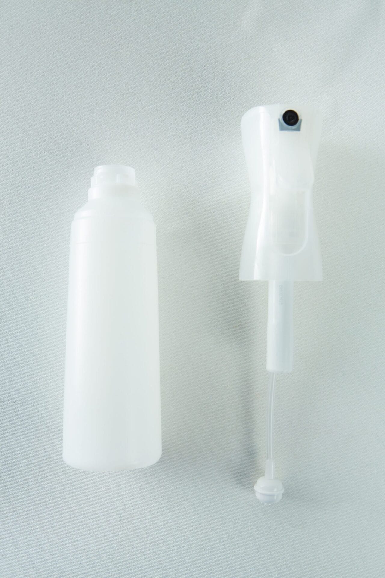 The Spray Bottle Atomiser Mushroom fine mist 300ml and a white plastic spray bottle with a trigger are set against a light background.