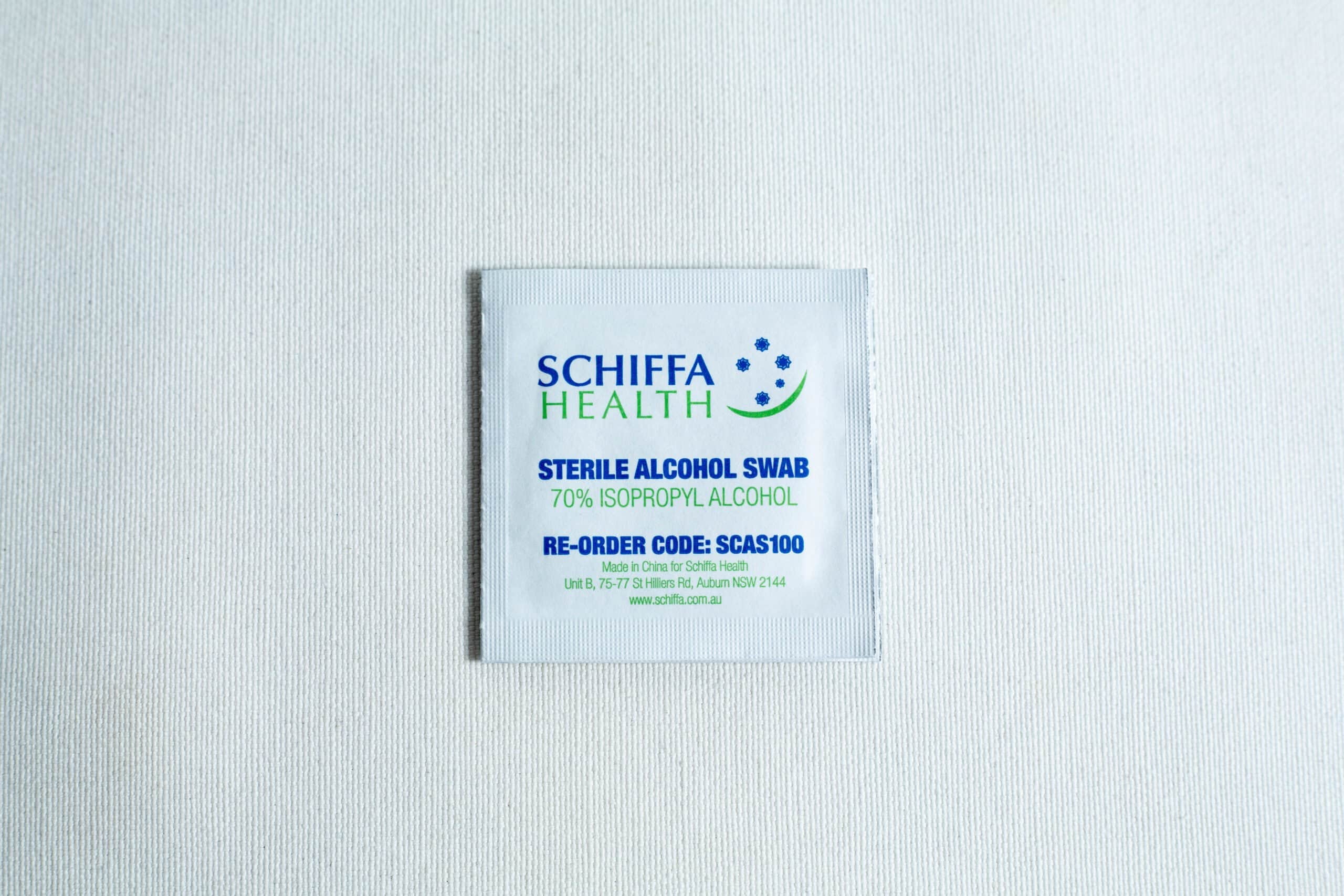 A box of 100 Sterile Alcohol Wipes / Swabs / Pads sits on a white surface.