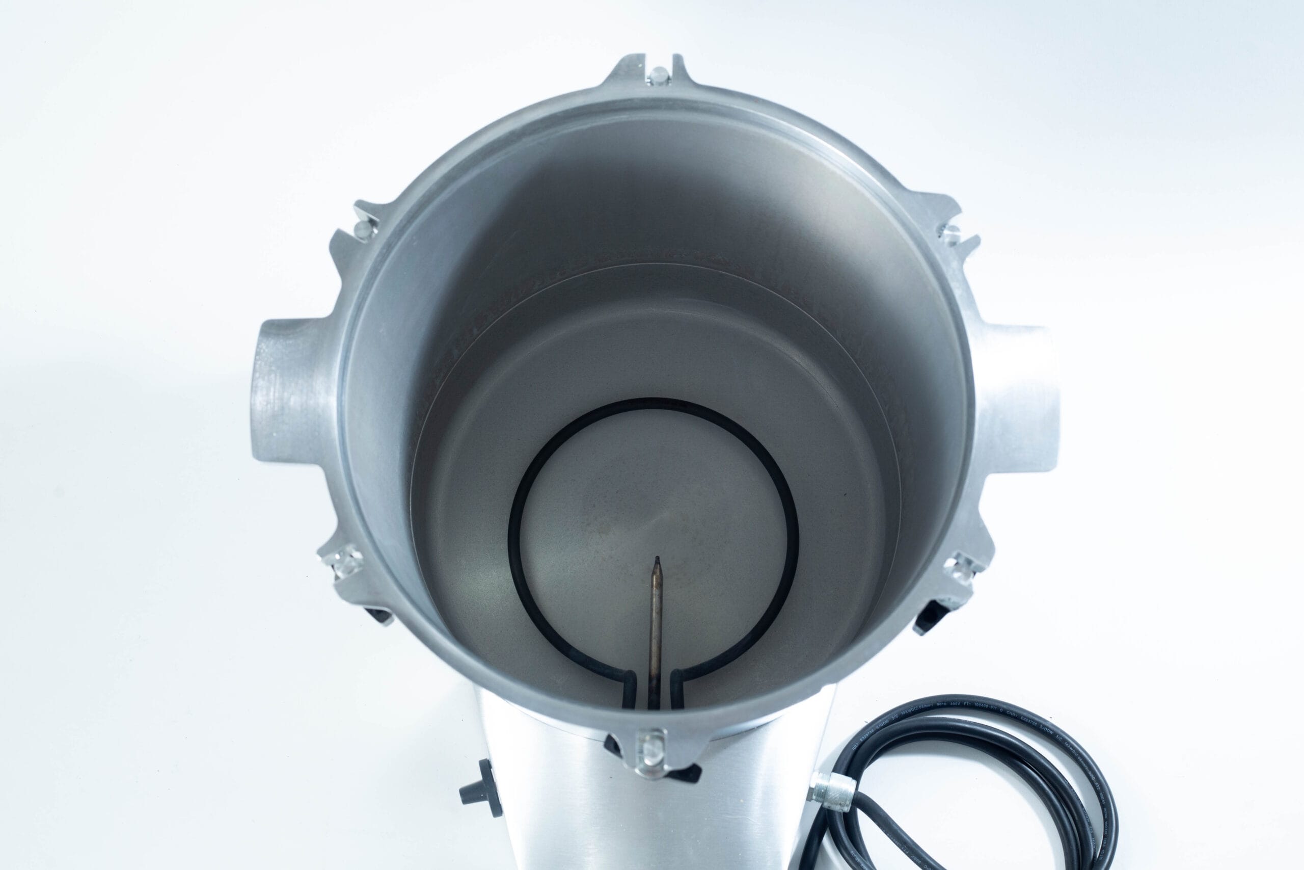 Top-down view of an empty stainless steel brewing kettle with a heating element and attached power lead.