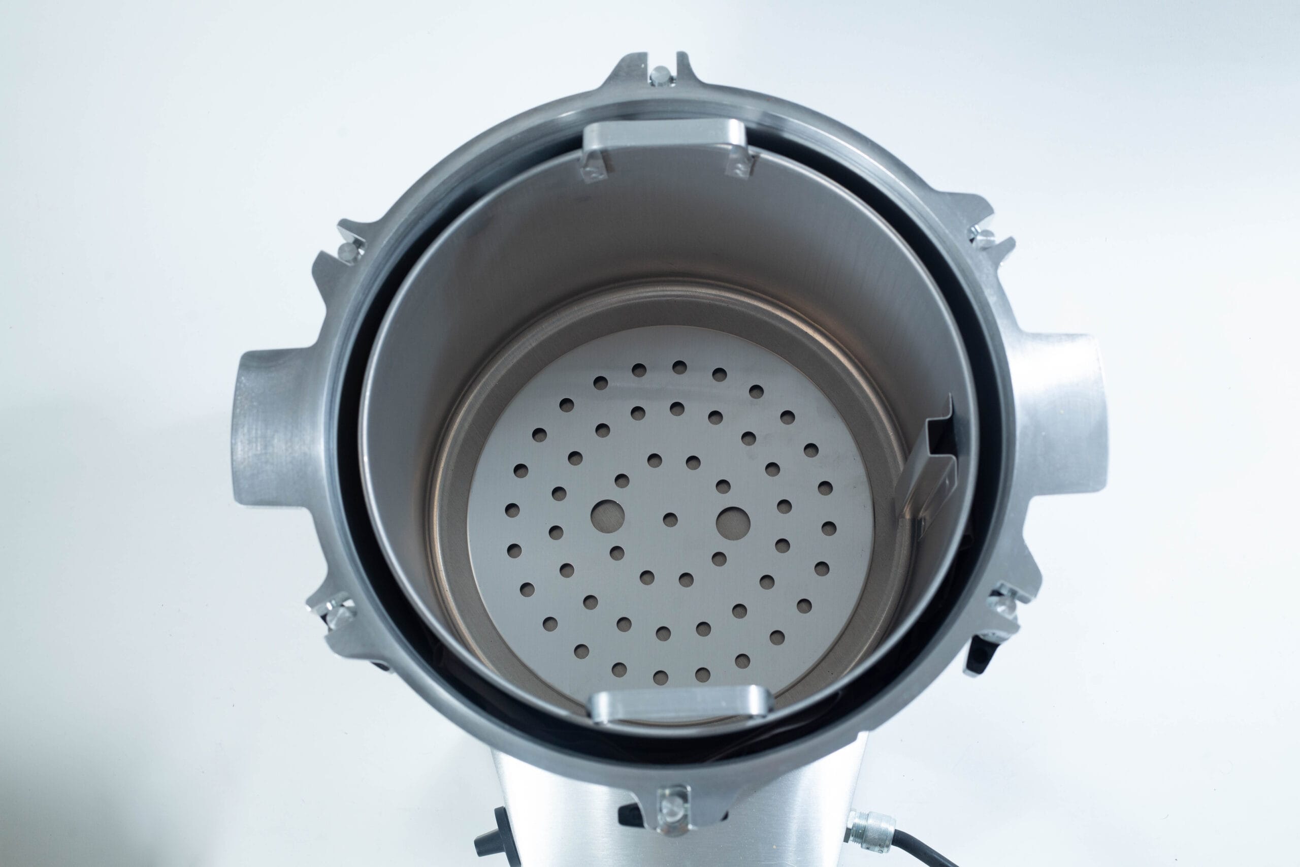 Top view of an empty stainless steel steamer pot with a perforated insert.