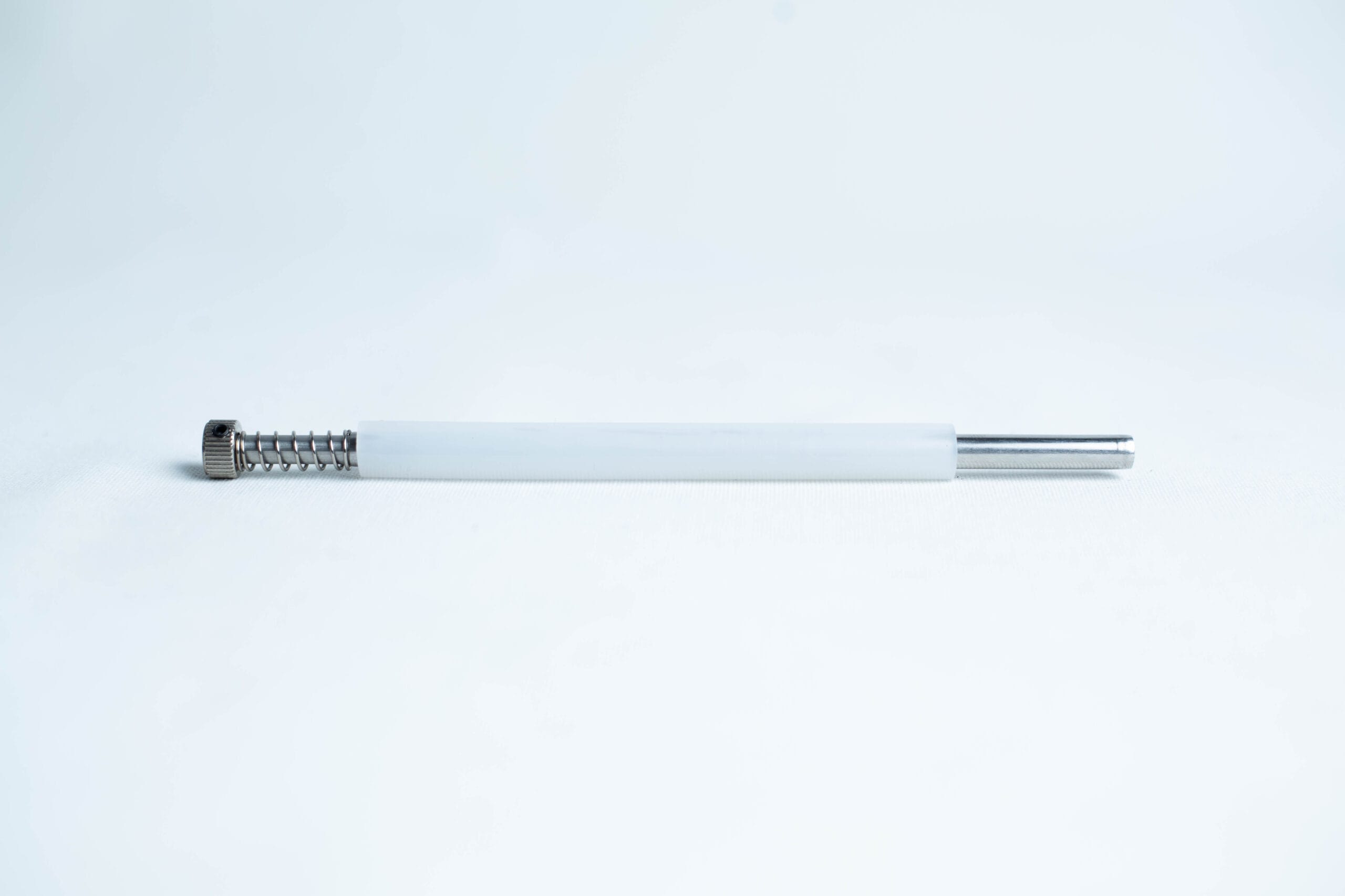 A single pen ink refill with a white barrel and metal tip on a plain white background.