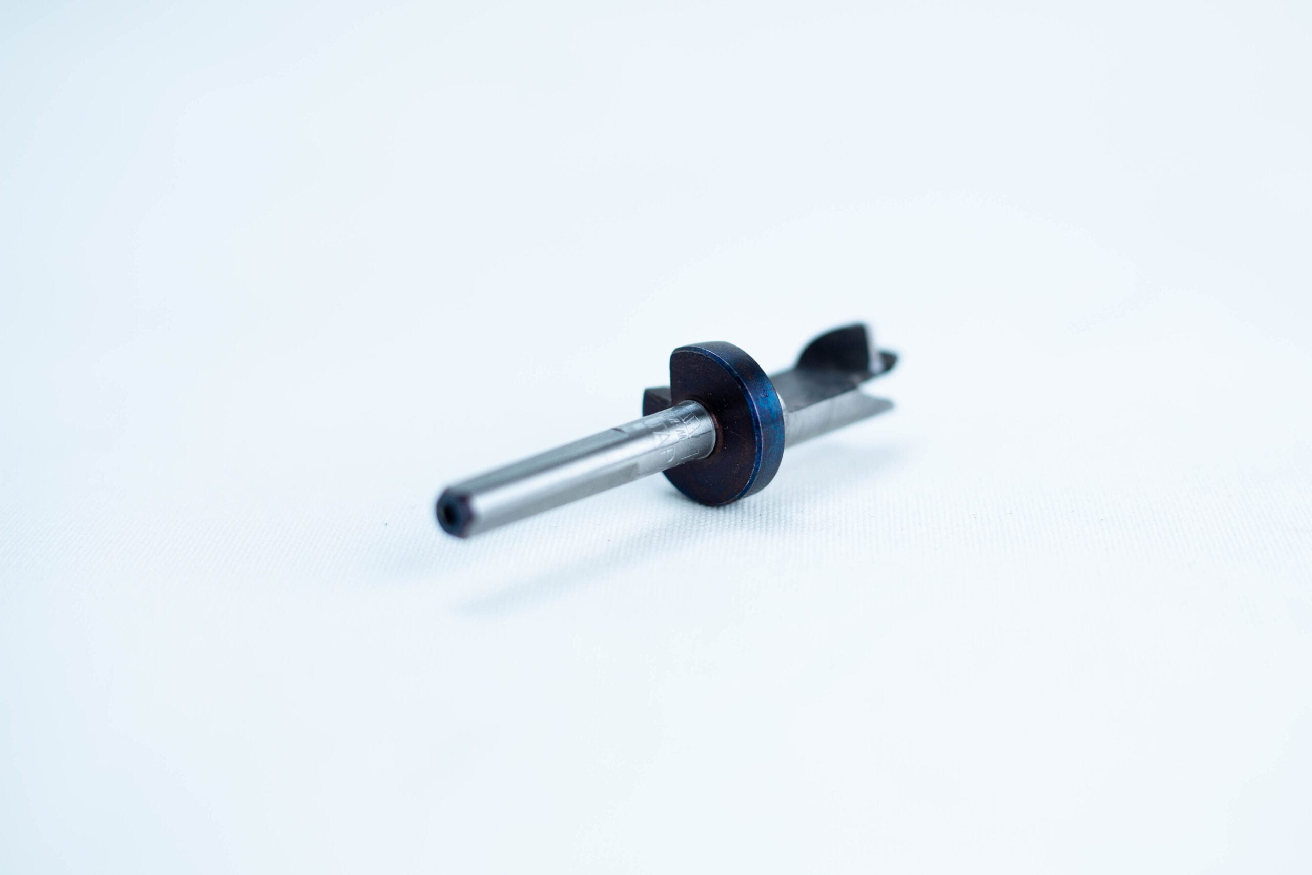 A small metal and plastic mechanical part on a white background.