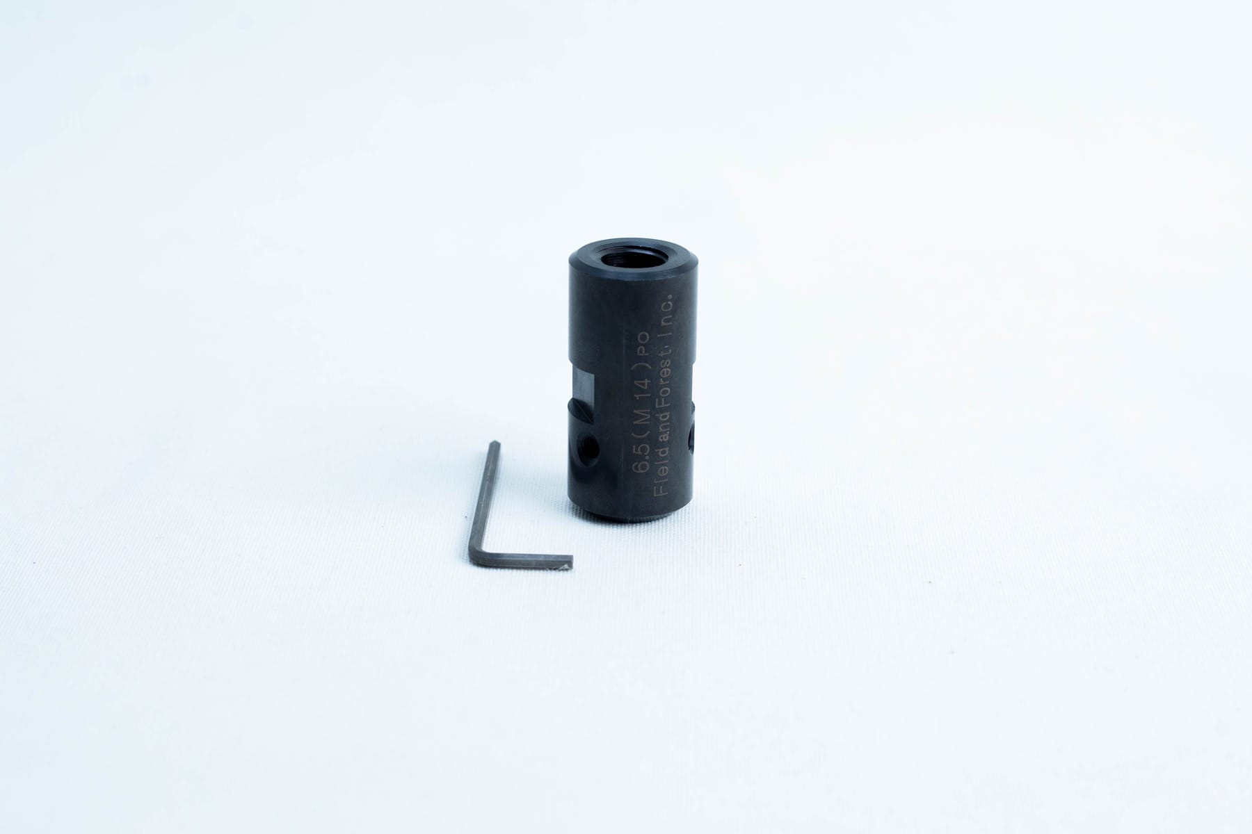 A black cylindrical metal tool and an L-shaped hex key on a white background.