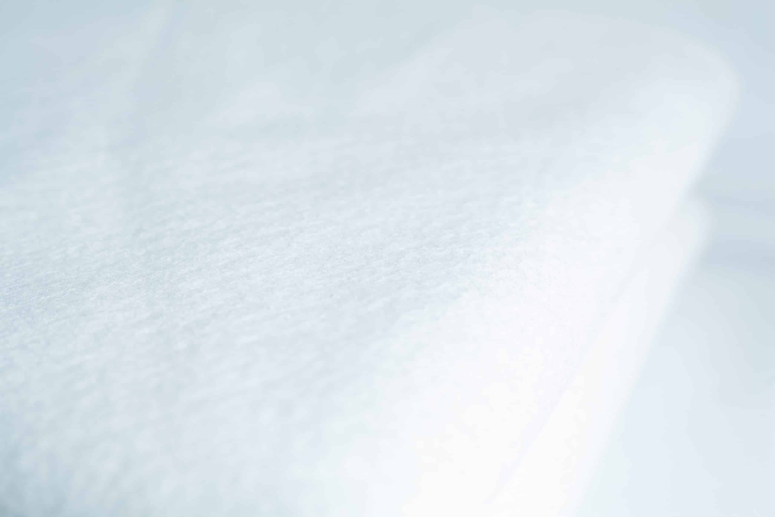 Close-up of the Light Log Blanket, showcasing its soft, textured white fabric.