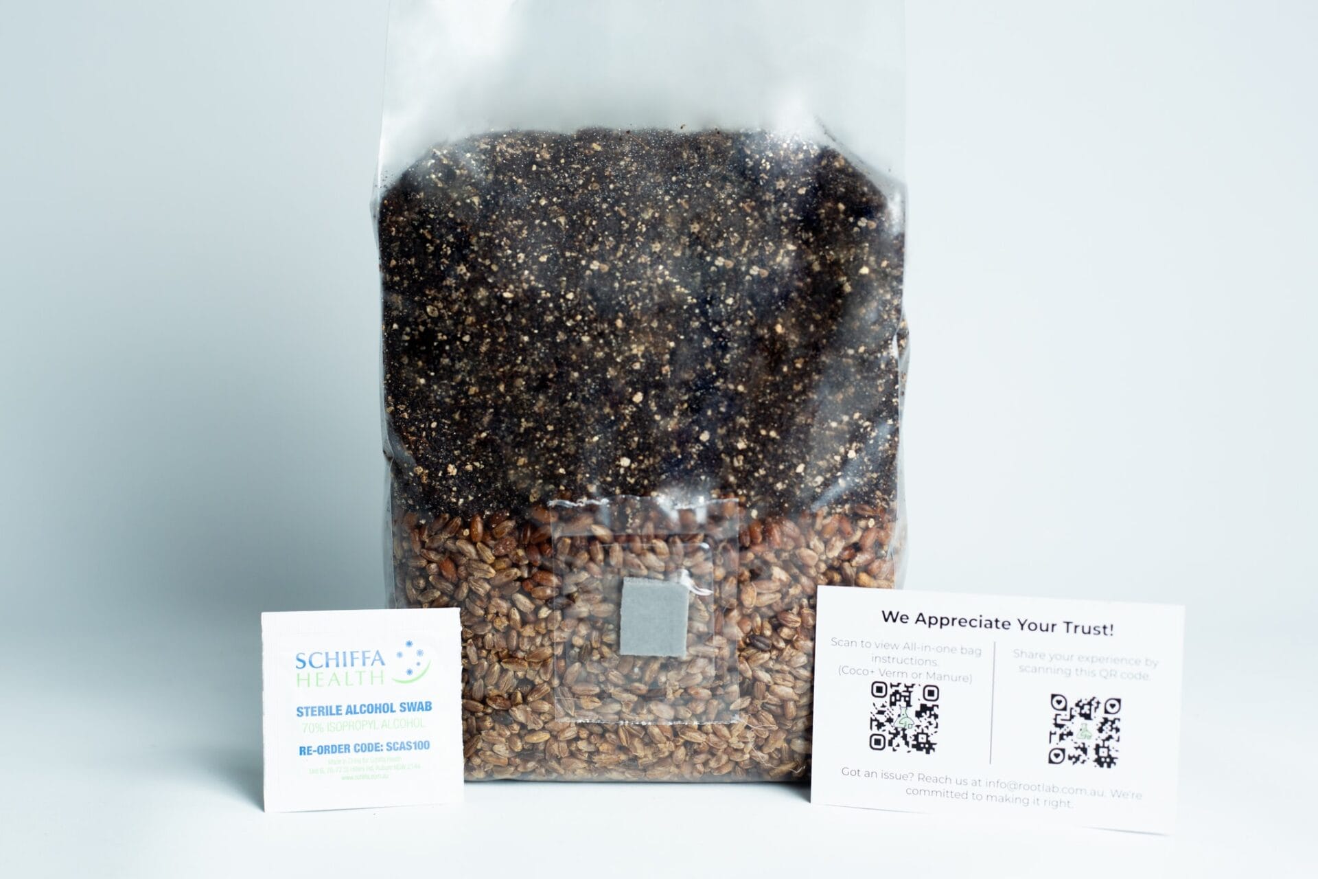 A clear bag of grains with two information cards beside it on a white surface.