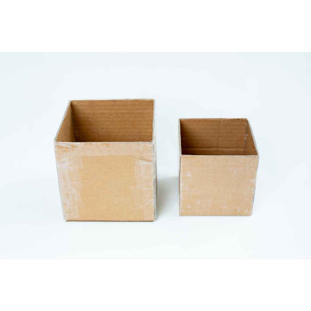 Two empty cardboard boxes, one larger and one smaller, placed side by side on a white background.