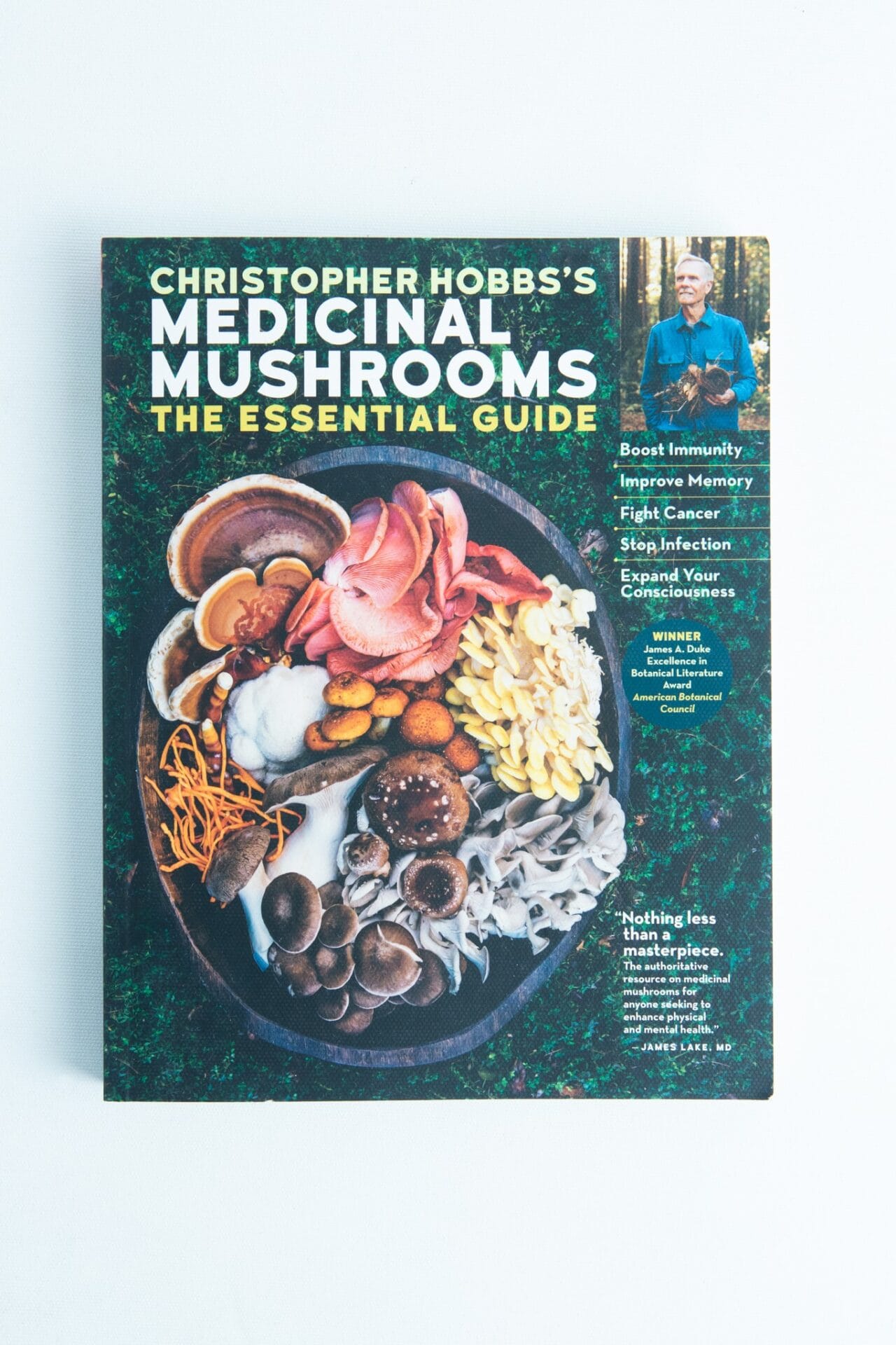 Book cover of Medicinal Mushrooms The Essential Guide by Christopher Hobbs, featuring a bowl filled with assorted mushrooms.