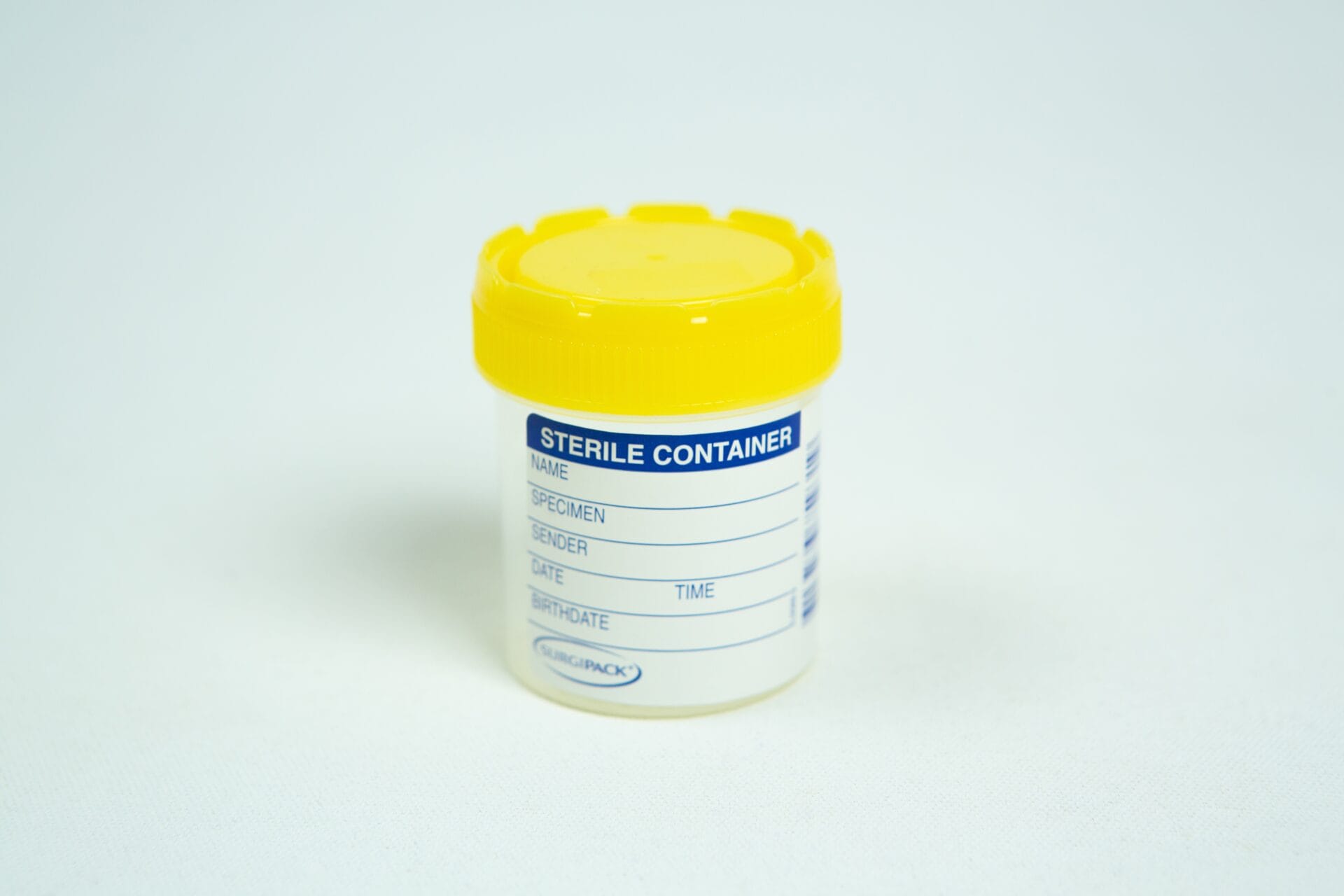 A sterile plastic specimen container with a yellow lid and labelling area—perfect for use with the Spore Print to Spore Syringe Transfer Kit.
