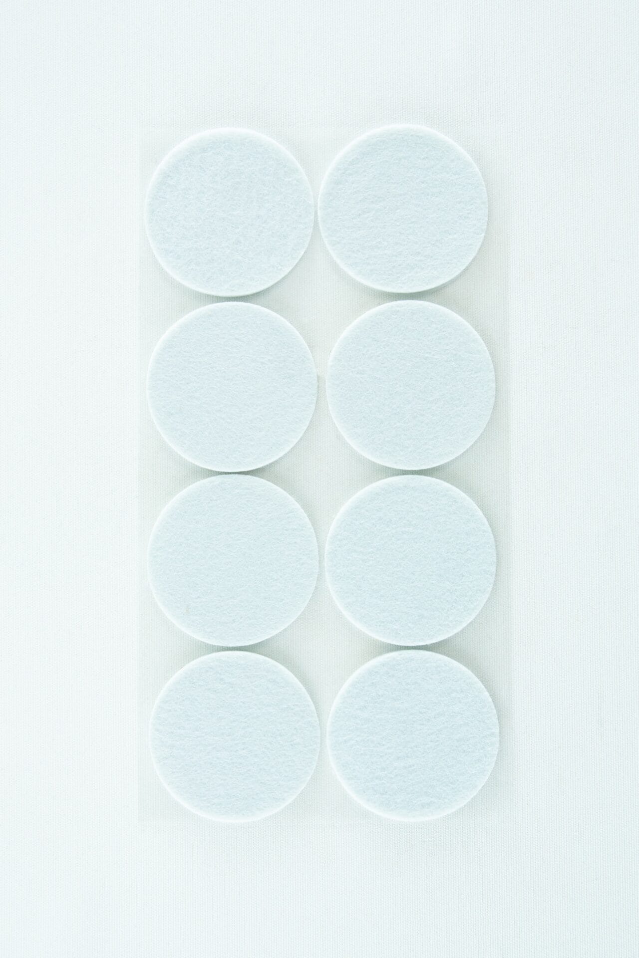 Eight white circular pads arranged in two columns on a white background.