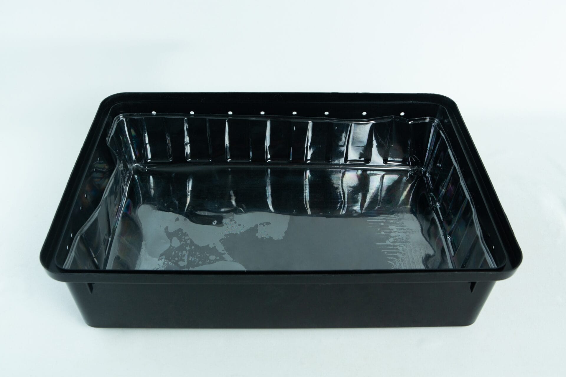 A black, rectangular plastic tray with a glossy finish on a white background.