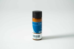 A small brown bottle labelled "Plant Cell Benzylaminopurine (6-BAP) Powder" with a blue label, black cap, and barcode sits on a white surface.