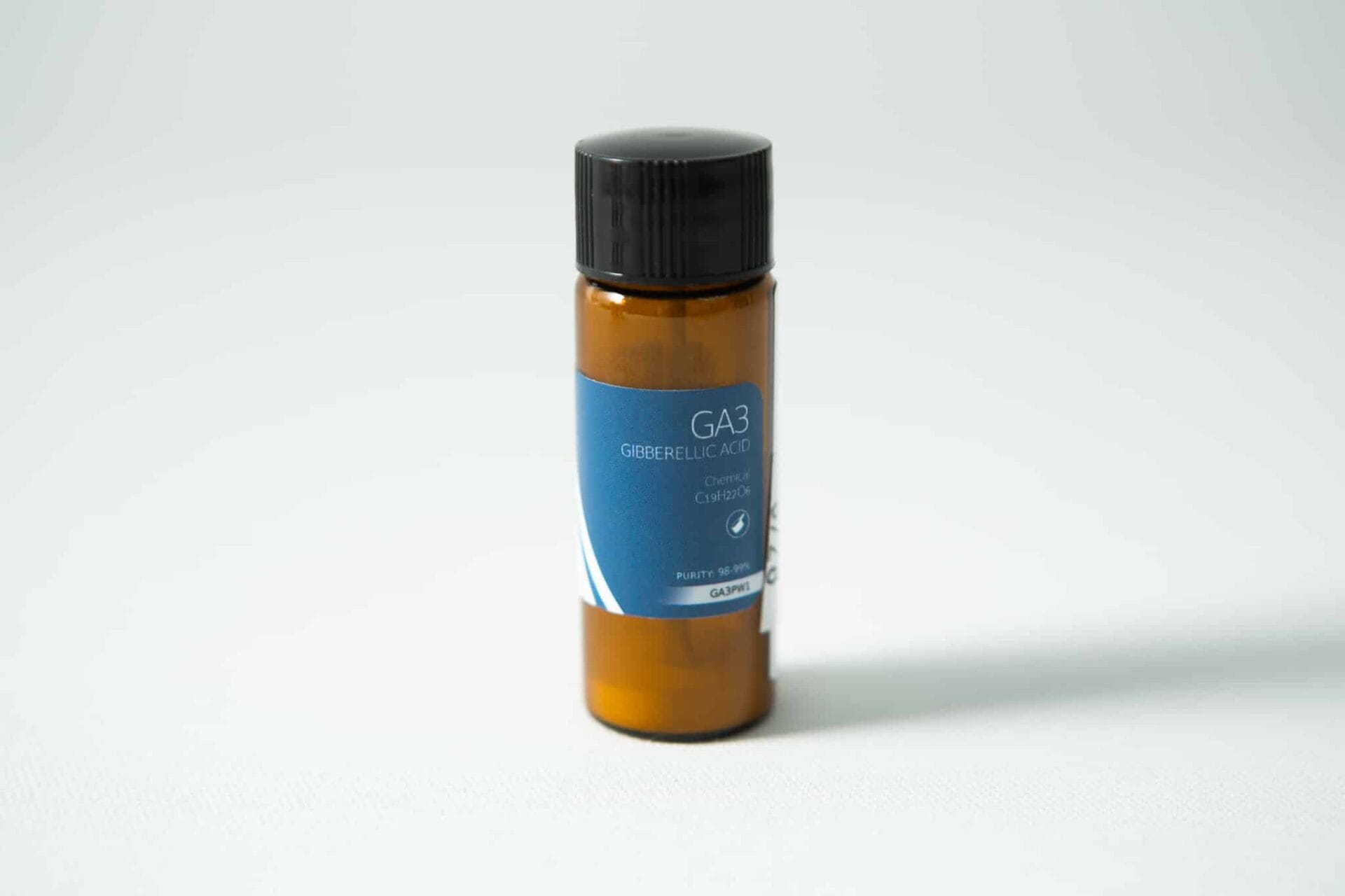 A small brown bottle with a blue label reading "Plant Cell Gibberellic Acid (GA3) Powder" sits on a white surface.