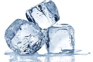 Three ice pack cubes are stacked together, each clear with water droplets and a small puddle forming at the base.