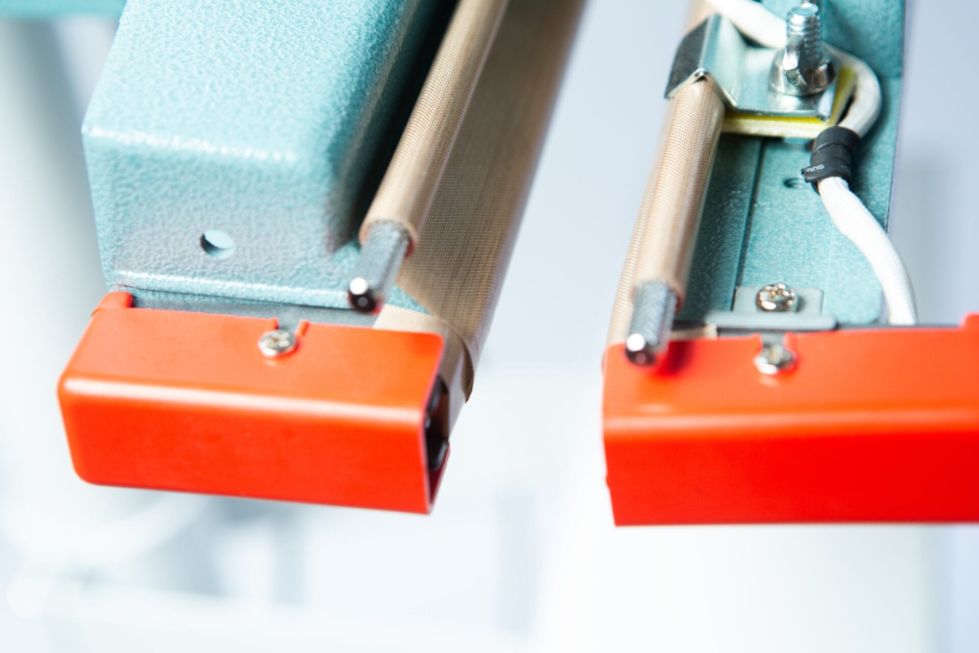 Close-up of the Vertical Foot Heat Sealer VHVD 450mm Double 10mm by Venus, featuring orange end caps and attached wires.