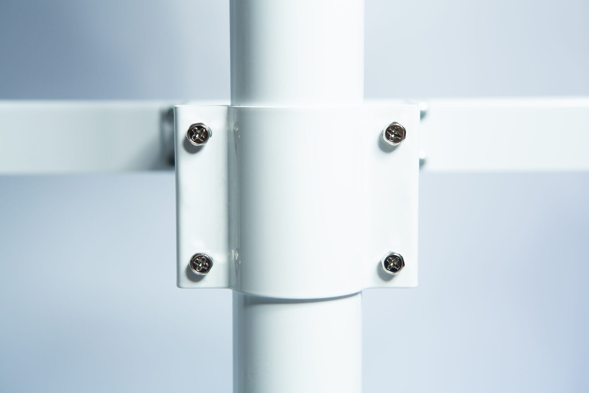 Close-up of a white metal fitting with four screws, connecting two metal bars to the upright pole of the Venus Vertical Foot Heat Sealer VHVD 450mm Double 10mm.