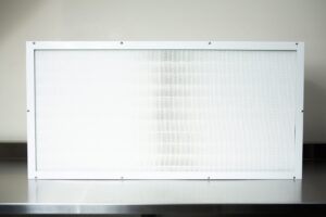 The Laminar Flow Hood H14 with pre-filter (120x60x35cm) features a rectangular white-framed air filter, shown on a metallic surface against a light background.